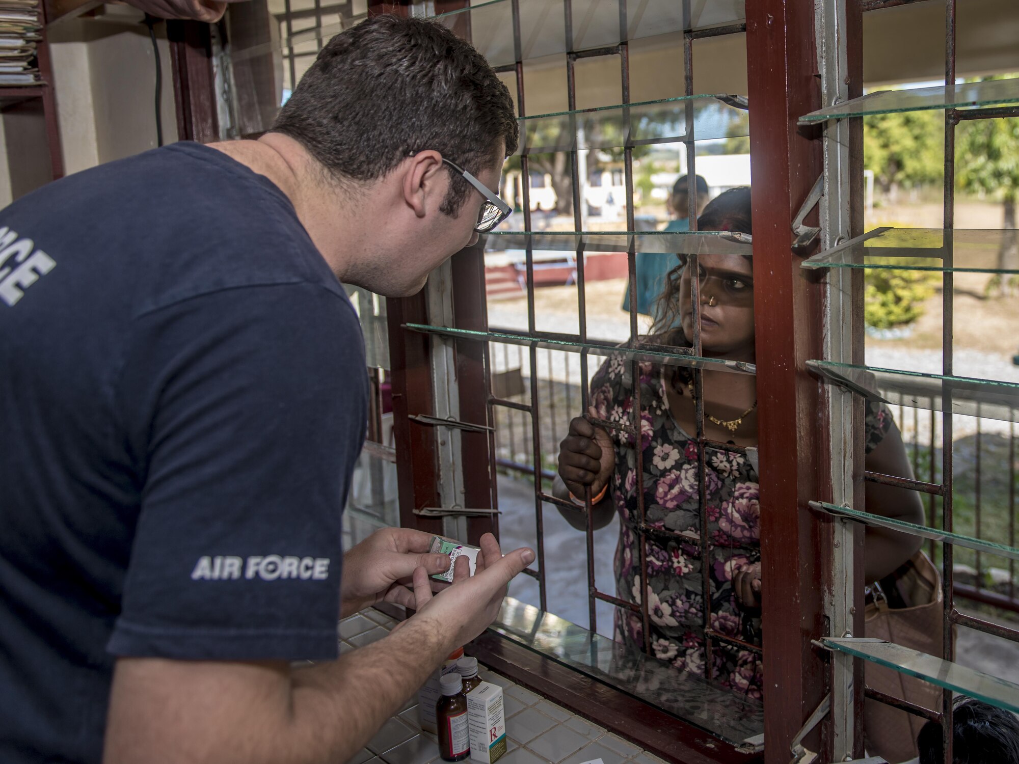 Royal Australian Air Force (RAAF) Flying Officer Luke Laws, left, a pharmaceutical officer with the 3rd Aeromedical Evacuation Squadron at RAAF Base Richmond, Australia, explains to a patient how to administer her medicine during Pacific Angel 17-3 at Tagitagi Sangam School and Kindergarten in Tavua, Fiji, July 20, 2017. The Australians were joined by four other regional nations including Vanuatu, Indonesia, the Philippines and France, aside from the U.S. and Fiji combining to provide humanitarian assistance and civil military operations, promoting regional military-civilian-nongovernmental organization cooperation and interoperability. (U.S. Air Force photo/Tech. Sgt. Benjamin W. Stratton)