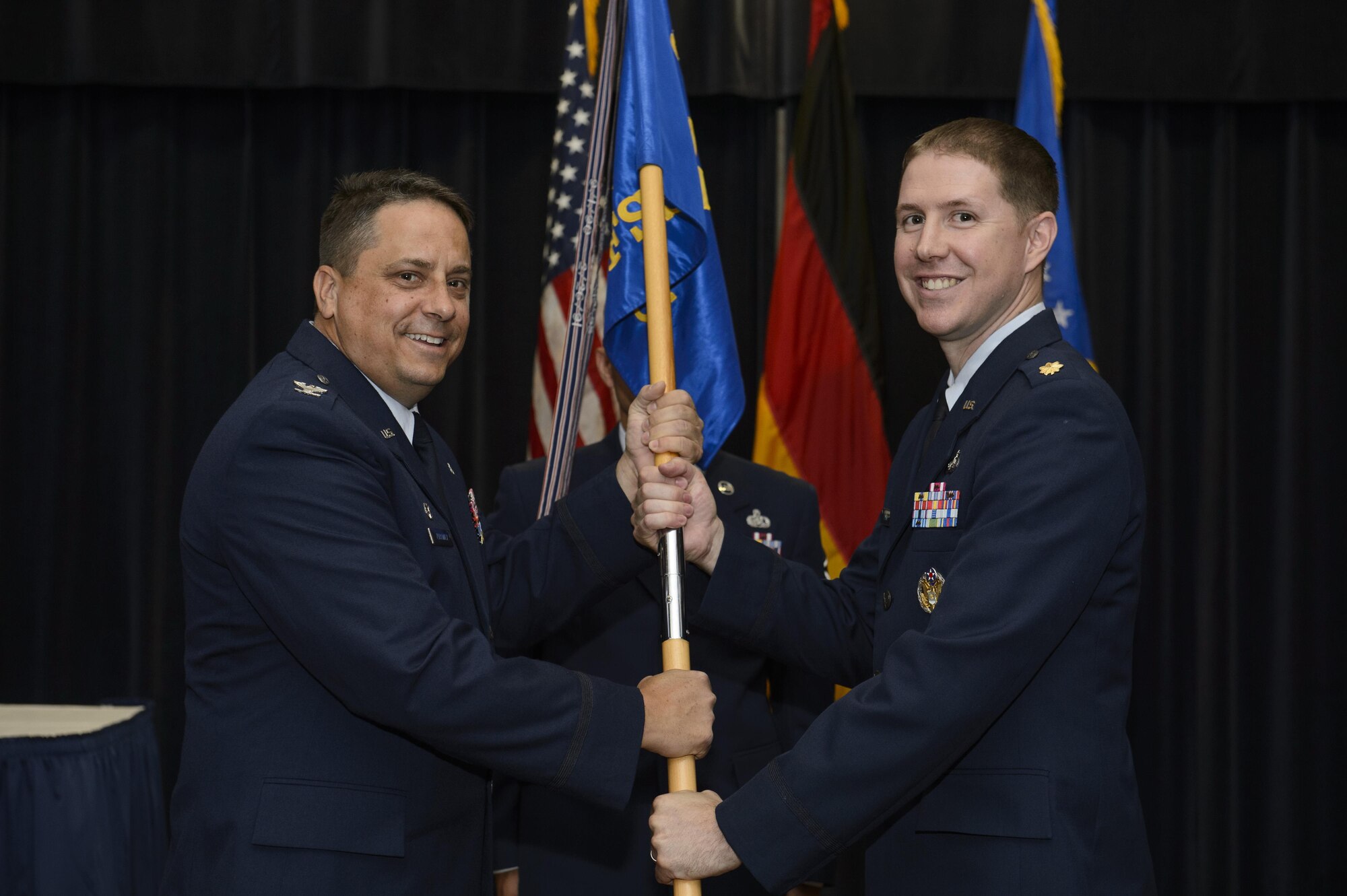 U.S. Air Force Col. Steven Zubowicz, left, 52nd Mission Support Group commander, gives the ceremonial guidon to U.S. Air Force Maj. Robert Clark, right, incoming 52nd Force Support Squadron commander, during the 52nd FSS change of command ceremony at Spangdahlem Air Base, Germany, July 21, 2017. (U.S. Air Force photo by Staff Sgt. Jonathan Snyder)