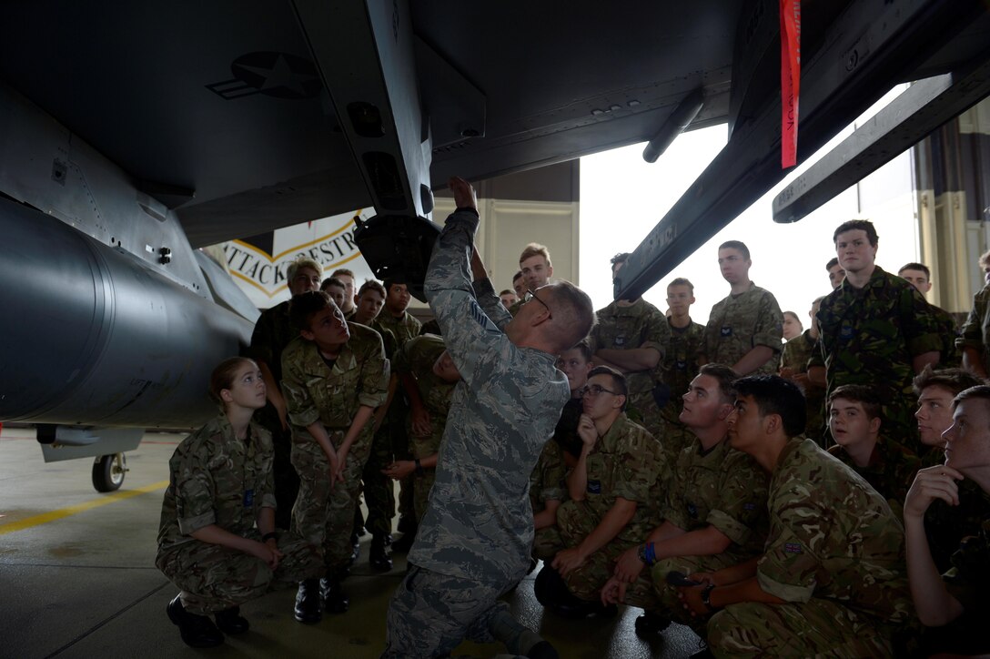 Master Sgt. Jason Tremmel, 52nd Maintenance Group loading standards crew team chief, talks about the F-16 Fighting Falcon to Royal Air Force Air Cadets at Spangdahlem Air Base, Germany, July 20, 2017. The cadets visited several different squadrons around base to give them a glimpse into U.S. Air Force operations. (U.S. Air Force photo by Staff Sgt. Jonathan Snyder)