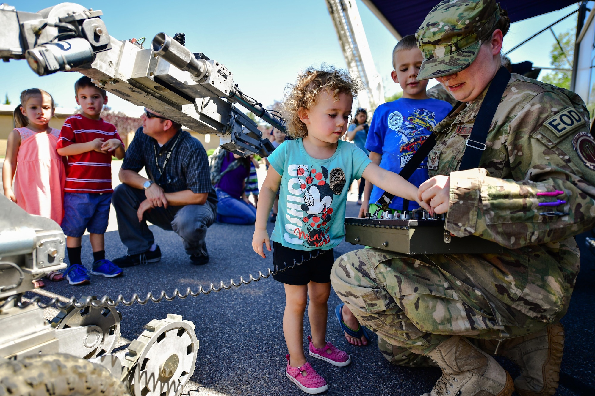 Emily Mears operates an Explosive Ordnance Disposal robot with EOD Technician Tech. Sgt. Molly Callen during a 'Military in Action' event, Hill Air Force Base, Utah, July 18, 2017. Event attendees were given demonstrations and access to equipment by units from across Hill AFB. (U.S. Air Force photo/R. Nial Bradshaw)