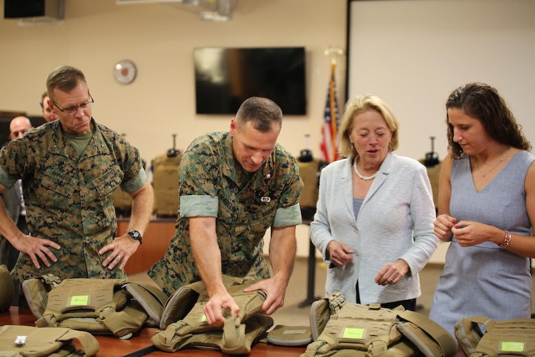 Massachusetts Congresswoman Niki Tsongas joins Marine Corps Systems Command acquisition experts aboard Marine Corps Base Quantico, Virginia, July 11, for a sneak peek at the latest gear for the 21st Century Marine. In a series of ongoing efforts, the Corps and the Army are collaborating to develop, test and deliver ever-better capabilities for Marines and Soldiers. From left: Brig. Gen. Joseph Shrader, MCSC commander; Lt. Col. Chris Madeline, program manager for Infantry Combat Equipment; Rep. Tsongas; and Mackie Jordan, an engineer in PM ICE. (U.S. Marine Corps photo by Emily Greene)