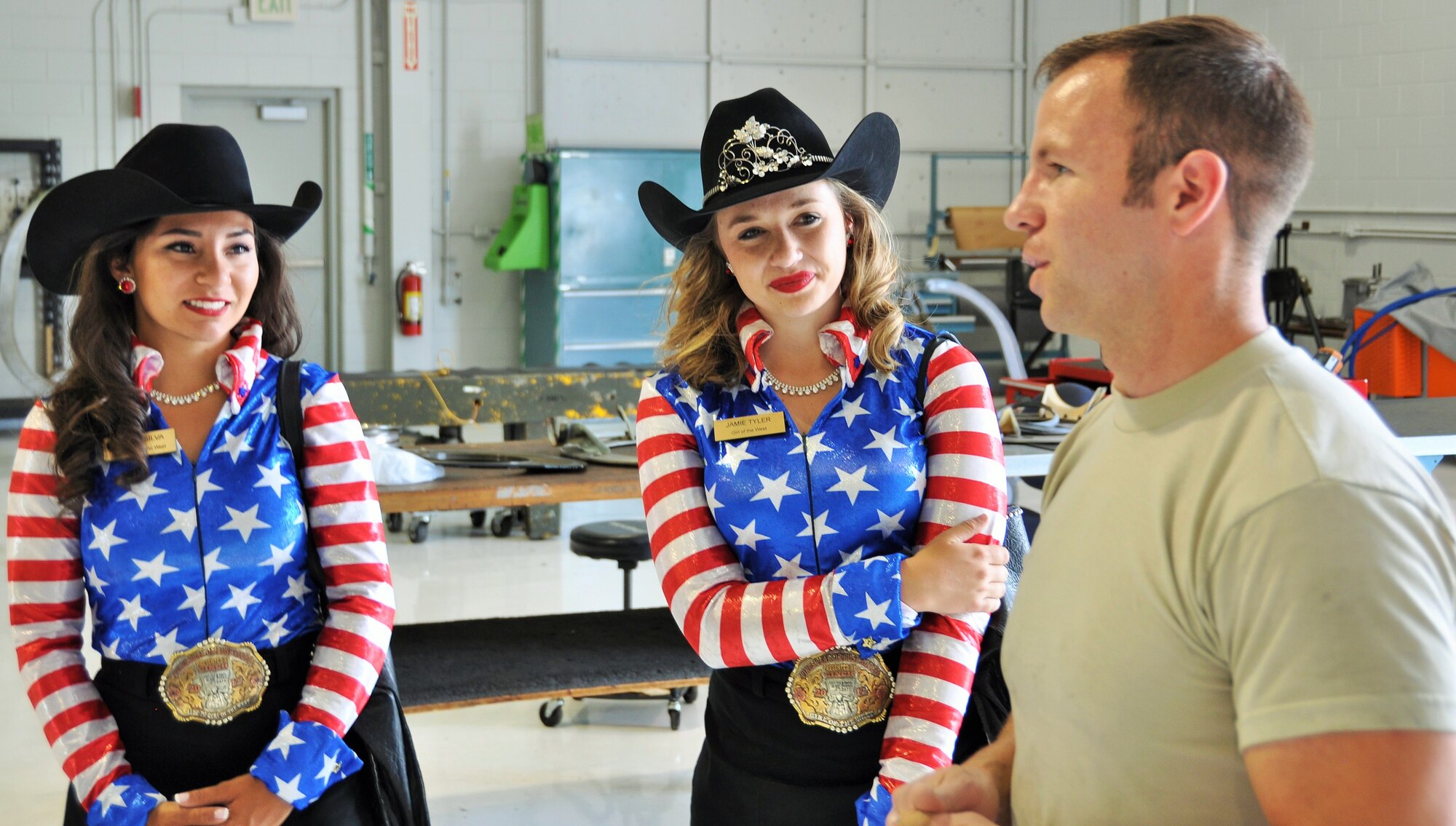 Senior Airman Josh Miranda talks about his job as an aerospace propulsion journeyman in the 302nd Maintenance Squadron propulsion shop with the 2017 Pikes Peak or Bust Rodeo ambassadors, the Girls of the West. Jaime Tyler, center, the 2017 PPoB Rodeo Girl of the West and her aide, Sierra Silva, left, visited the 302nd Airlift Wing to tour a C-130 Hercules aircraft and learn about the 302nd AW Reserve missions, at Peterson Air Force Base, Colo., June 28, 2017. (U.S. Air Force photo/Daniel Butterfield)
