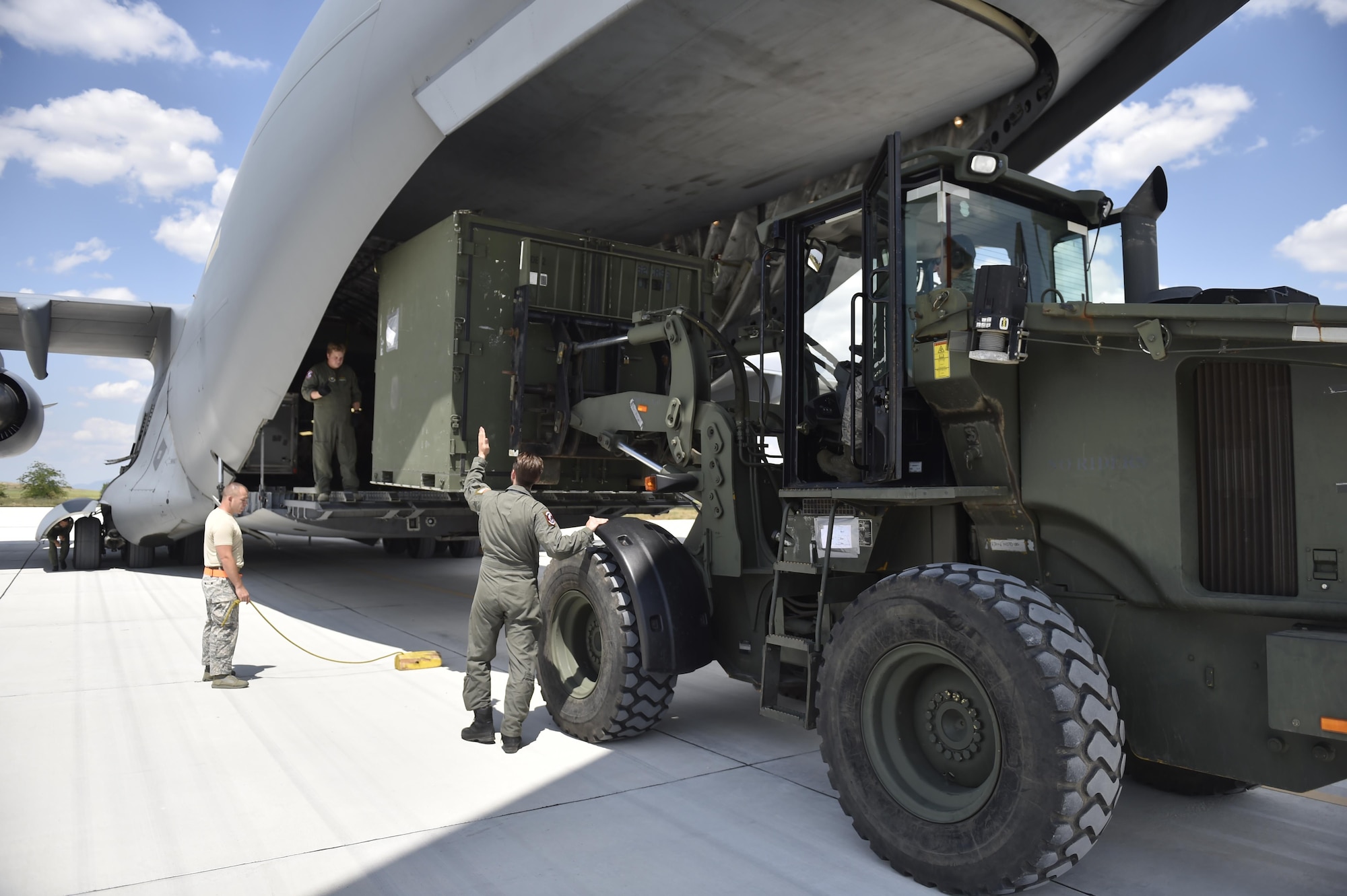 A loadmaster directs the positioning of a forklift to load cargo onto a C-17 Globemaster during Exercise Saber Guardian ‘17 at Bezmer Air Base, Bulgaria, July 19, 2017.  The largest of the Black Sea region exercises, SG17 highlights participant deterrence capabilities, specifically the ability to mass forces at any given time anywhere in Europe to support the security and stability of the Black Sea region.  (U.S. Air Force Photo by Tech. Sgt. Liliana Moreno/Released)