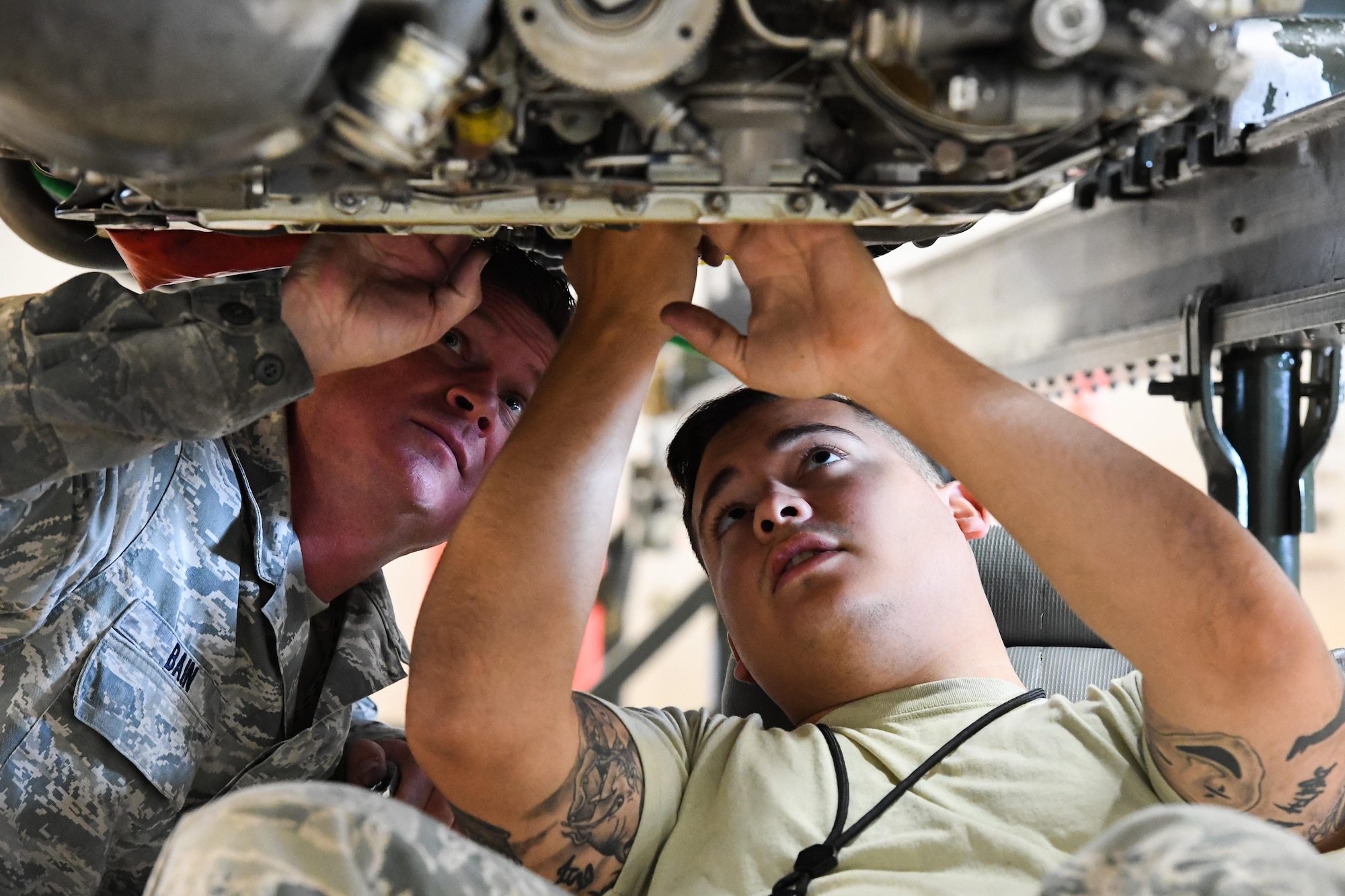 Staff Sgt. Cody Bain, left, 419th Maintenance Squadron Propulsion Flight and Senior Airman Elias Oquendo, 388th Maintenance Squadron Propulsion Flight, perform final maintenance and inspections on an F-16 jet engine, Hill Air Force Base, Utah, July 13, 2017. The total force unit overhauls F110-GE-100 engines for Hill, Holloman and Nellis Air Force Bases. (U.S. Air Force photo/R. Nial Bradshaw)