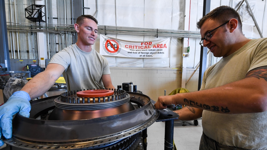 Airman 1st Class Joseph Cockerham, left, 388th Maintenance Squadron Propulsion Flight and Staff Sgt. Christopher Basile, 419th Maintenance Squadron Propulsion Flight, tear down an F-16 compressor unit, Hill Air Force Base, Utah, July 13, 2107. The total force unit produces overhauled F110-GE-100 engines for Hill, Holloman and Nellis Air Force Bases. (U.S. Air Force photo/R. Nial Bradshaw)
