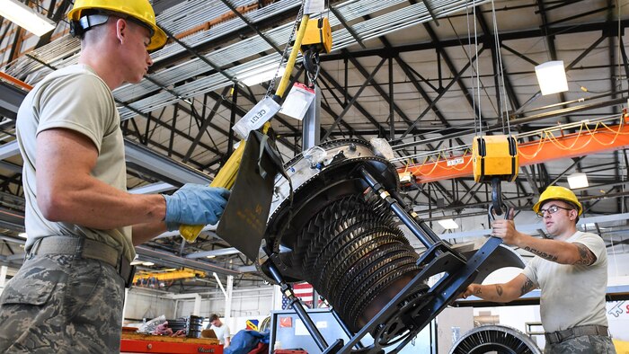 Airman 1st Class Joseph Cockerham, left, 388th Maintenance Squadron Propulsion Flight and Staff Sgt. Christopher Basile, 419th Maintenance Squadron Propulsion Flight, rotate the compressor unit of an F-16 engine, Hill Air Force Base, Utah, July 13, 2107. The total force unit produces overhauled F110-GE-100 engines for Hill, Holloman and Nellis Air Force Bases. (U.S. Air Force photo/R. Nial Bradshaw)