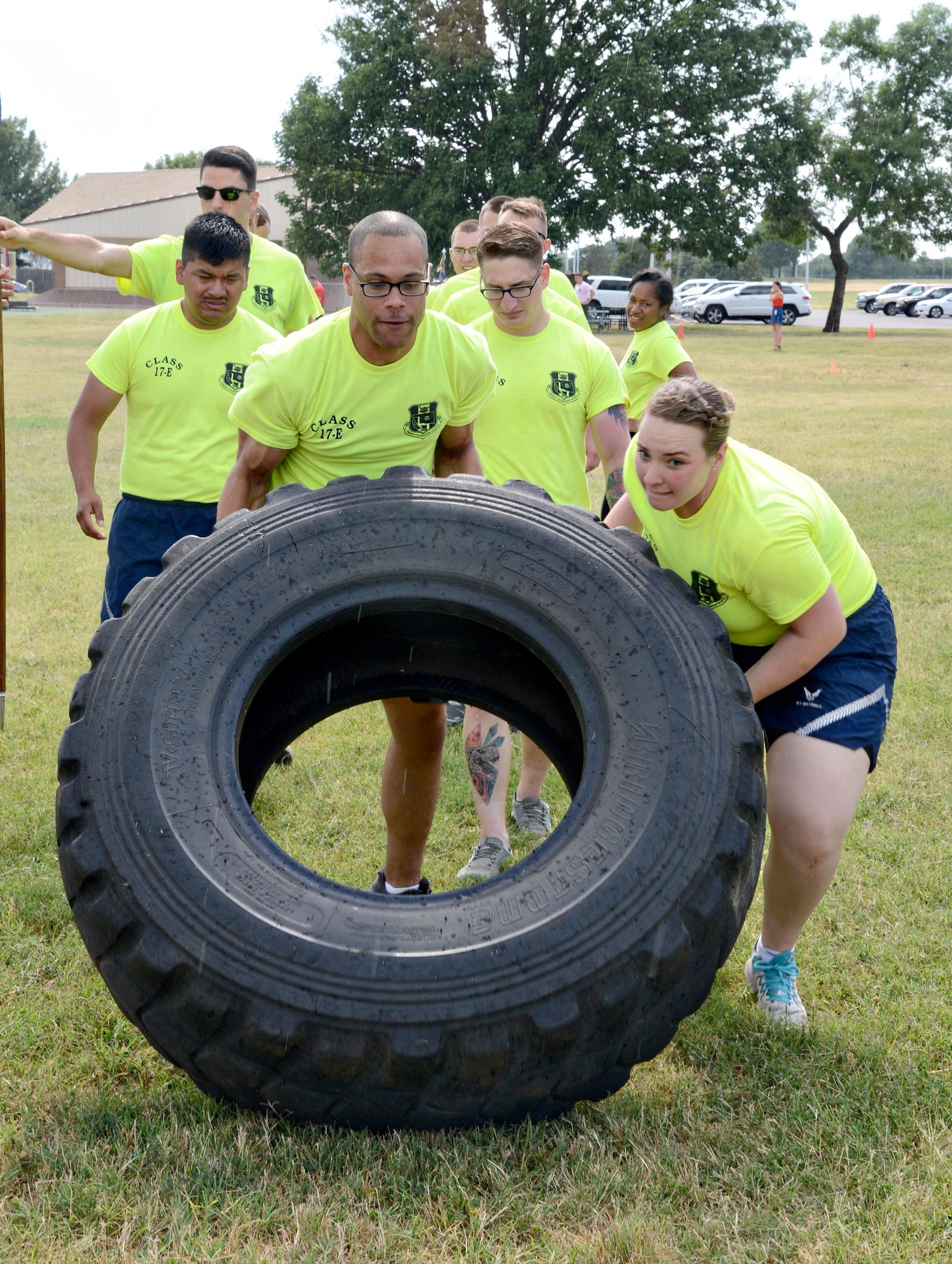 Senior Airmen Shane Sergent, 72nd Security Forces Squadron, and Julianna Divett, 507th Medical Squadron, work together to flip a tire during one of the stations in a Commandant’s PT exercise. Differing from regular PT exercises, the Commandant’s PT challenges apply curriculum that the students have studied, help promote team-building and help students observe strengths and weaknesses in themselves and each other, helping them to become stronger leaders. (Air Force photo by Kelly White)