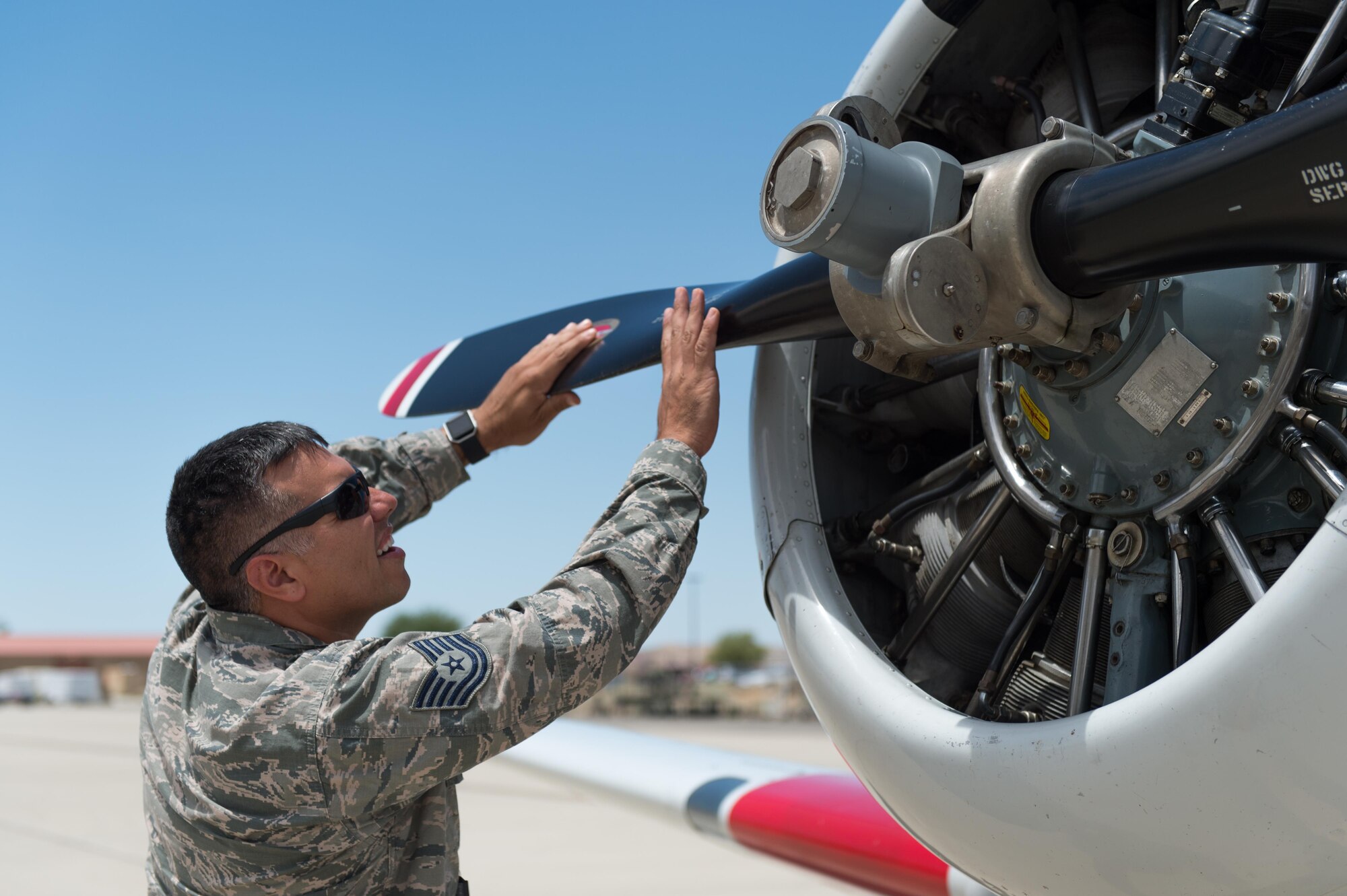 Tech. Sgt. Isaiah Chavez works on a T-6 on the ramp near the U.S. Air Force Test Pilot School. Chaves, a logistics manager with the Test Pilot School, is the 412th Test Wing Warrior of the Week. (U.S. Air Force photo by Kyle Larson)