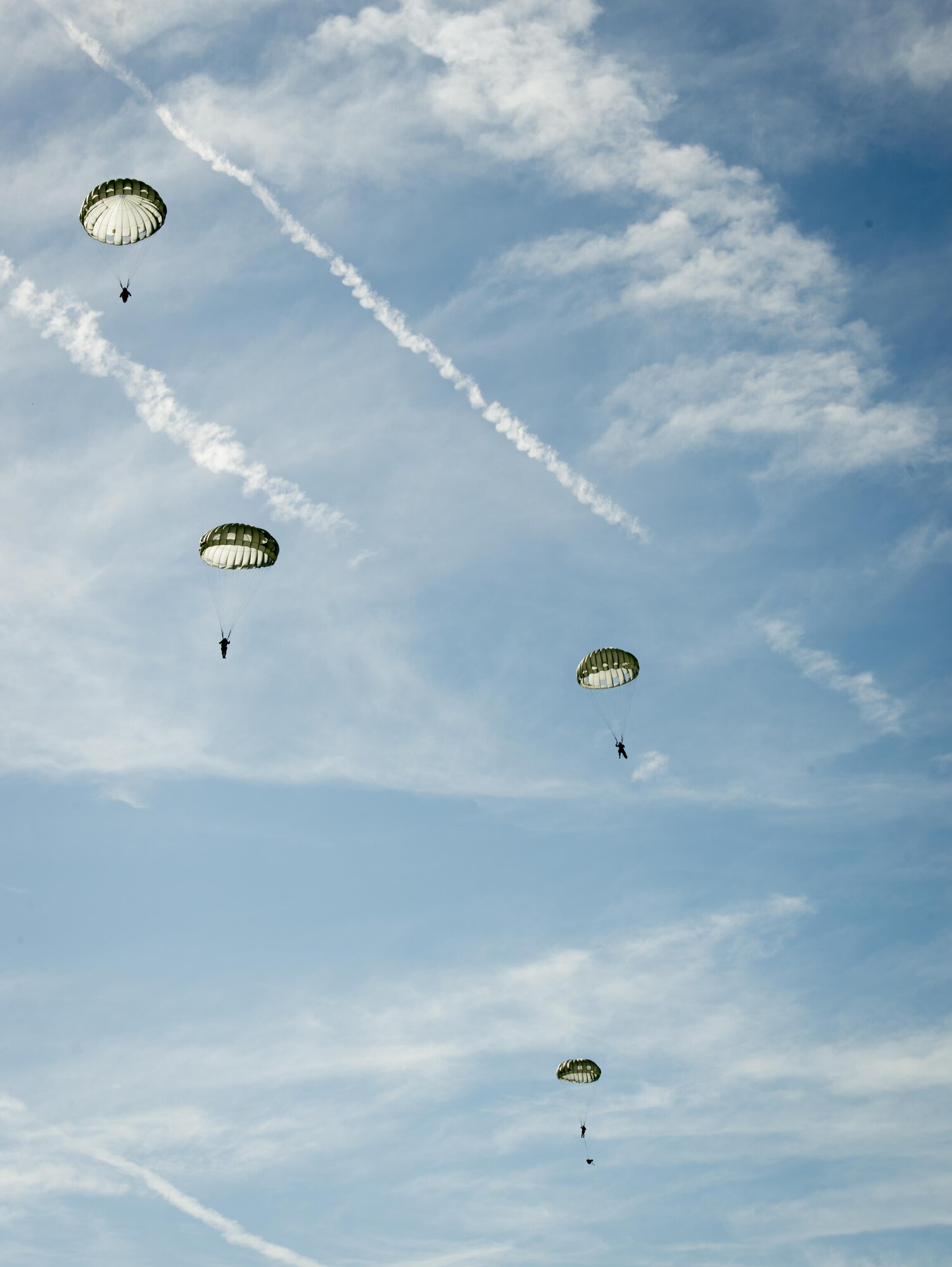 Service members from MacDill Air Force Base, Fla., parachute over Brooksville, Fla., July 15, 2017. During the operation, five to six service members jumped at a time using MC-6 type parachutes with T-11 reserve parachutes. (U.S. Air Force photo by Senior Airmen Mariette Adams)