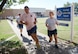 Senior Airman Evan Wilson, 963rd Airborne Air Control Squadron, and class leader Senior Airman Rebecca Cowan, 507th Operations Support Squadron, along with the rest of Class 17-E, run laps in front of the ALS schoolhouse during PT. ALS holds PT four days per week, with a Commandant’s PT on Fridays. (Air Force photo by Kelly White)