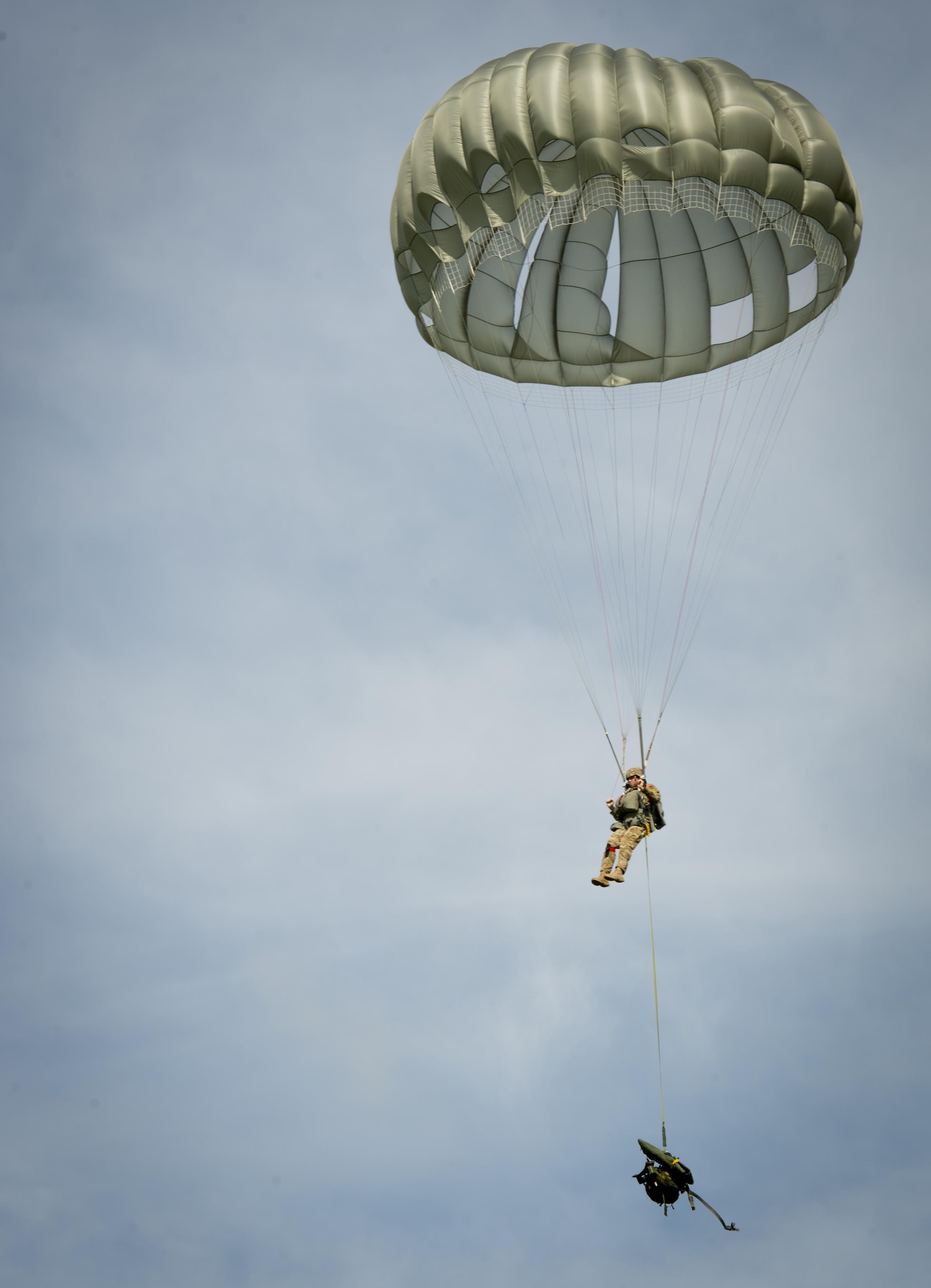 A service member from MacDill Air Force Base, Fla., parachutes during a training mission over Brooksville, Fla., July 15, 2017. Once the parachute has been activated, the jumper must direct the parachute so they can land in the drop zone. (U.S. Air Force photo by Senior Airmen Mariette Adams)