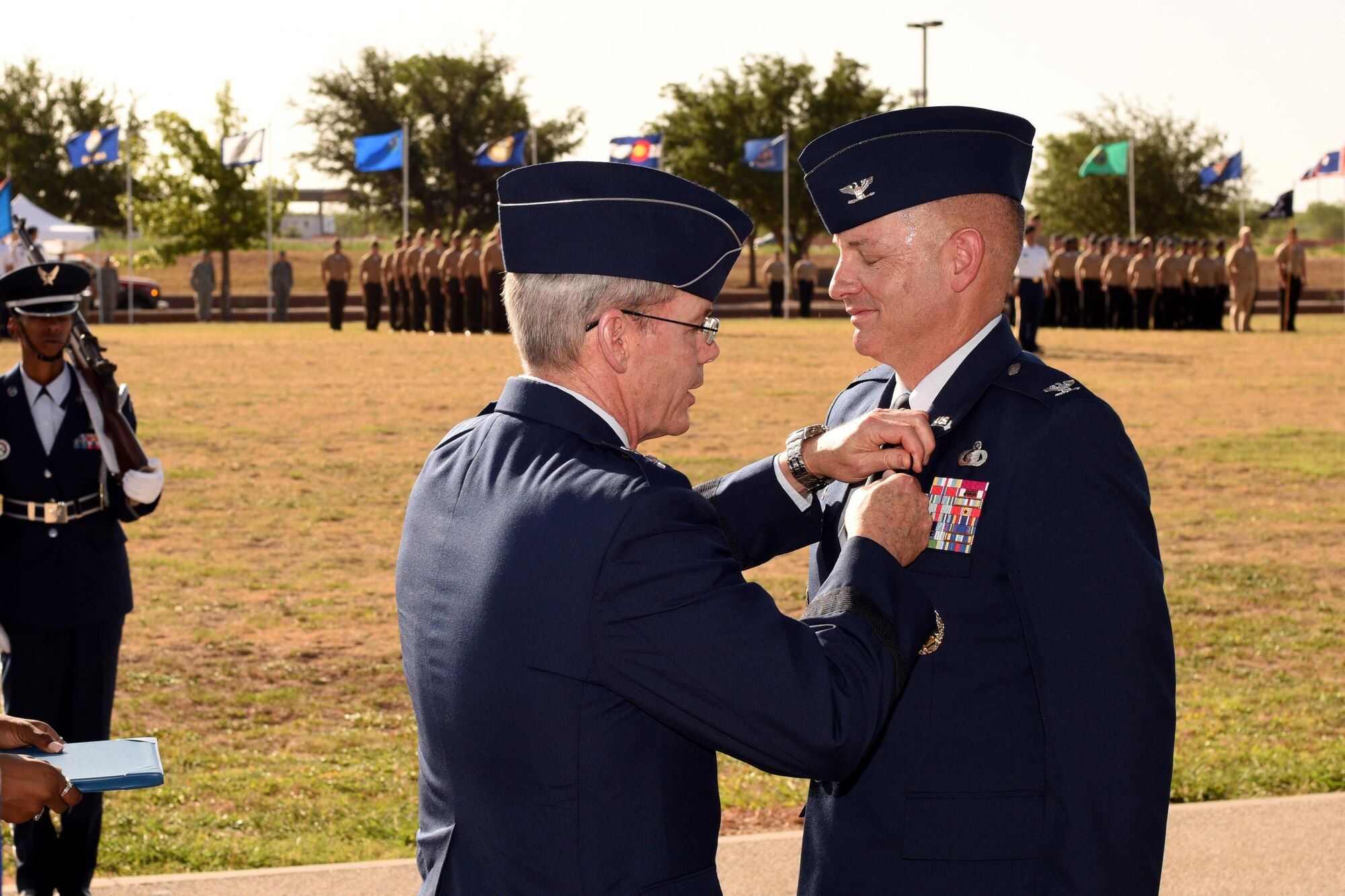 U.S. Air Force Maj. Gen. Robert LaBrutta, 2nd Air Force Commander, presents the Legion of Merit award to Col. Michael Downs, 17th Training Wing Commander, at the parade field on Goodfellow Air Force Base, Texas, July 21, 2017. The Legion of Merit is a military award of the United States Armed Forces that is given for exceptionally meritorious conduct in the performance of outstanding services and achievements. (U.S. Air Force photo by Airman 1st Class Randall Moose/Released)