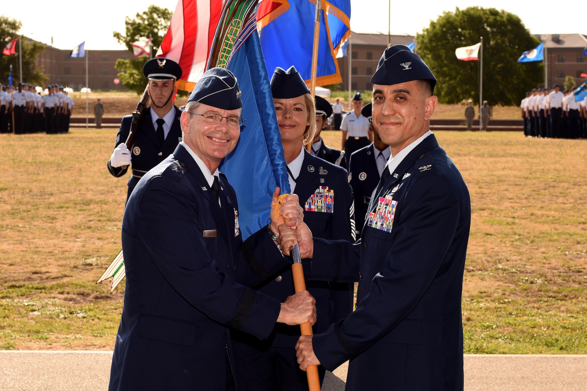 U.S. Air Force Maj. Gen. Robert LaBrutta, 2nd Air Force Commander, passes the guideon to Col. Ricky Mills, 17th Training Wing Commander, at the parade field on Goodfellow Air Force Base, Texas, July 21, 2017. Mills commanded the 17TRW from July 2017 until June 2019. (U.S. Air Force photo by Airman 1st Class Randall Moose/Released)