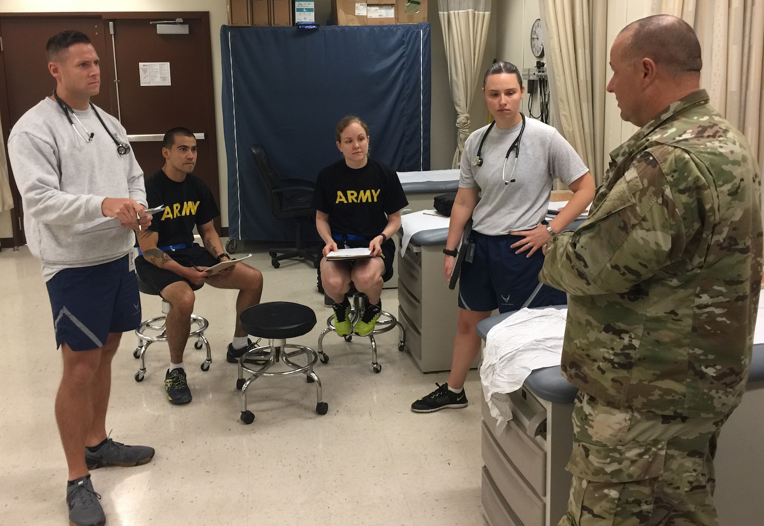 Maj. John Davinson (right), Interservice Physician Assistants Program, or IPAP, instructor, speaks to students in the IPAP course