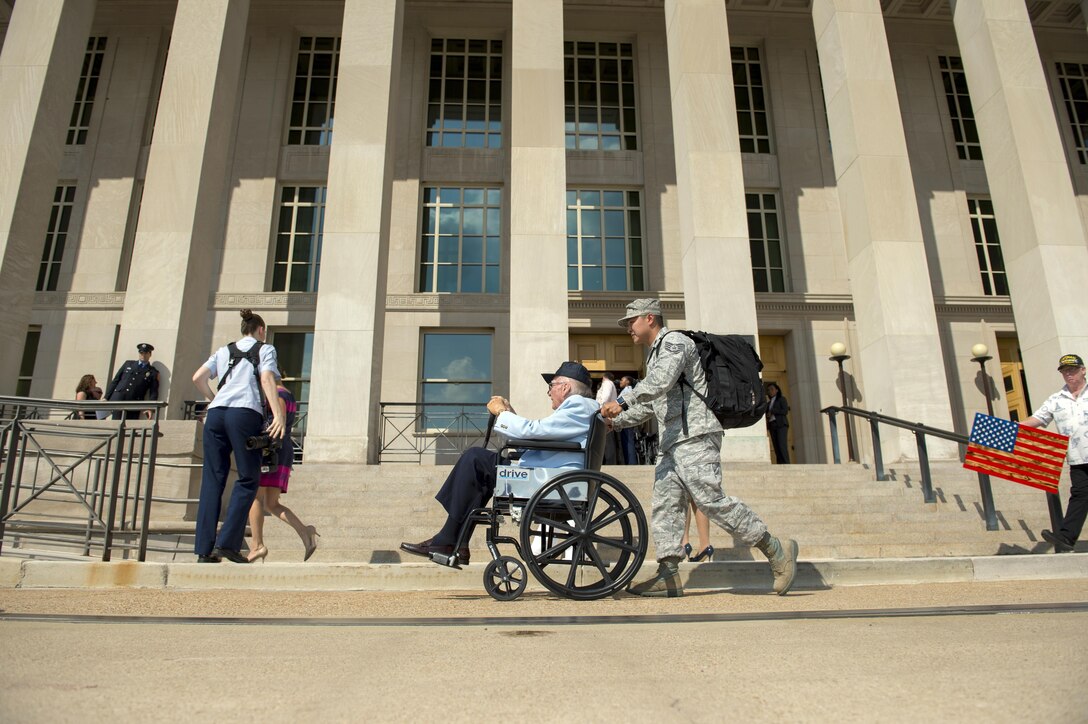 Air Force Staff Sgt. Frederick Taguba assists USS Arizona survivor Navy veteran Donald Stratton enter the Pentagon, July 17, 2017. Three survivors of the USS Arizona, which was sunk during the Japanese attack on Pearl Harbor, toured the Pentagon. DoD photo by EJ Hersom