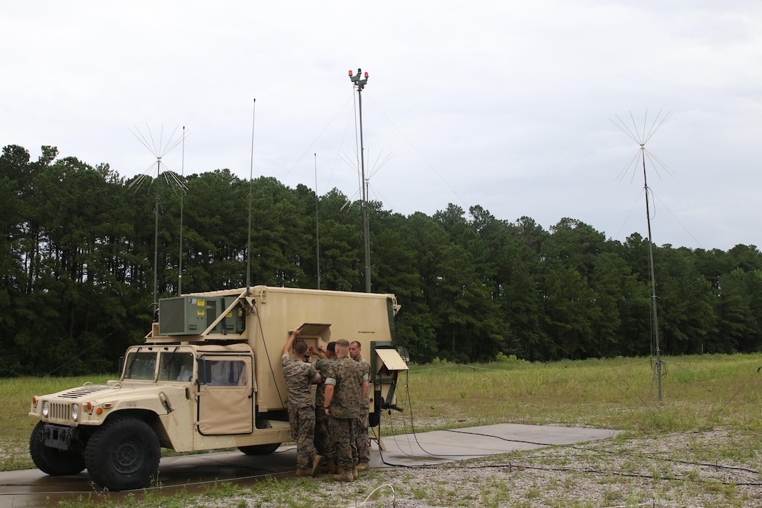 Radar technicians with Detachment Charlie, connect the operator shelter of the AN/TPS-31A V7 Air Traffic Navigation, Integration, and Coordination System to the radar vehicle during a week-long training exercise at Marine Corps Air Station Cherry Point, North Carolina, July 19, 2017. The ATNAVICS is a two-part expeditionary radar system capable of being transported via air, and provides an effective range of approximately 60 miles for air traffic control Marines. Det. C. is assigned to Marine Air Control Squadron 2, Marine Air Control Group 28, 2nd Marine Aircraft Wing. (U.S. Marine Corps Photo by Pfc. Skyler Pumphret/ Released)
