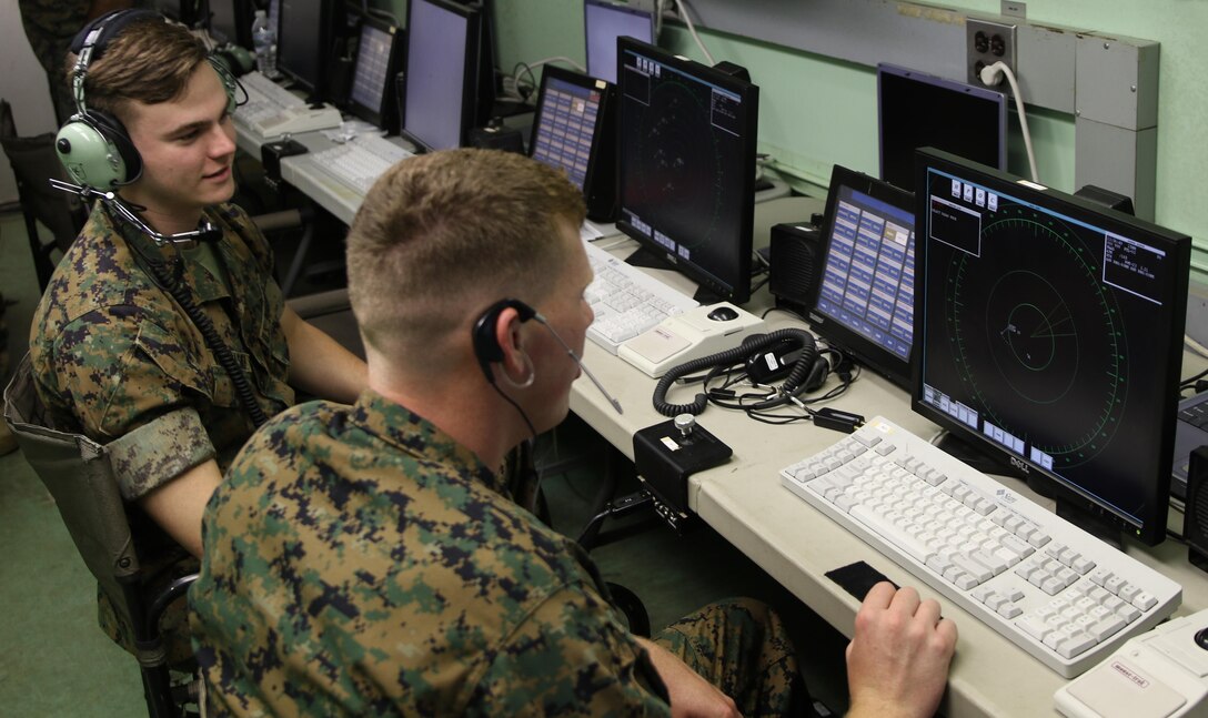 Lance Cpl. Evan Kowalski and Lance Cpl. Michael Hamilton monitor the display screens of the AN/TPS-31A V7 Air Traffic Navigation, Integration, and Coordination System during a week-long training exercise at Marine Corps Air Station Cherry Point, N.C., July 17, 2017. The ATNAVICS is an expeditionary radar system, capable of being transported by aircraft to help Marines monitor an established runway throughout areas of operation around the globe. Kowalski and Hamilton are air traffic controllers assigned to Air Traffic Control Crew 2, Headquarters and Headquarters Squadron, MCAS Cherry Point. (U.S. Marine Corps Photo by Pfc. Skyler Pumphret/ Released)