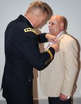 Lt. Gen. Jeffrey S. Buchanan, commanding general of U.S. Army North (Fifth Army), pins the Silver Star on Edward Iannuccilli during a ceremony July 7 at Joint Base San Antonio-Fort Sam Houston. The Silver Star had been awarded to then-Spec. 4 Iannuccilli but never presented. Iannuccilli, a combat medic in Vietnam, survived a medical evacuation crash April 7, 1970, then, disregarding the flames and exploding ammunition inside the helicopter, made several attempts before successfully rescuing the pilot. The pilot, and several other members of his unit, 159th Medical Evacuation Company, or Dustoff, attended the award ceremony, which coincided with Iannuccilli’s son, Michael, being promoted to lieutenant colonel. 