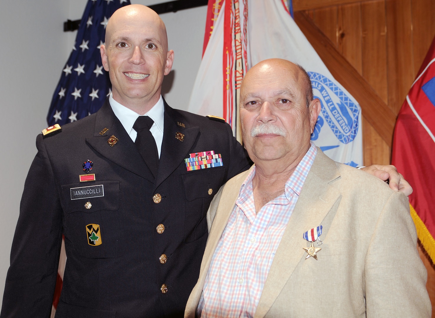 Newly promoted Lt. Col. Michael Iannuccilli (left), U.S. Army North (Fifth Army) stands with his father, Edward, following their ceremonies July 7 at Joint Base San Antonio-Fort Sam Houston. The elder Iannuccilli, received his Silver Star in a surprise ceremony following Lt. Col. Iannuccilli’s promotion. Edward’s heroism occurred April 7, 1970, in Vietnam, when as a combat medic he disregarded his own safety to rescue a pilot trapped inside a burning medical evacuation helicopter, while the enemy fired on him and ammunition inside the aircraft exploded. 