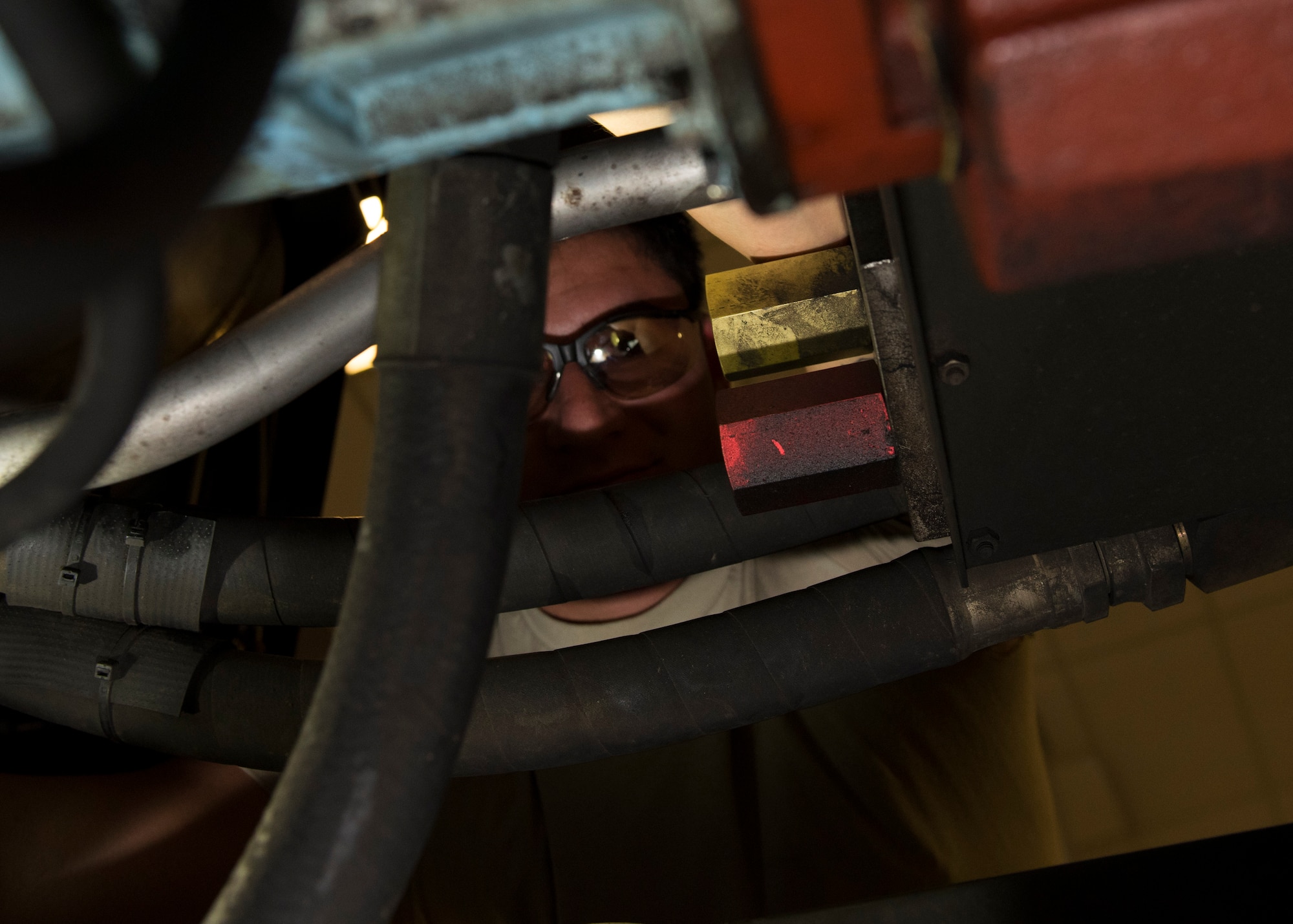 Senior Airman Austin Ready, 92nd Aerospace Ground Equipment journeyman, inspects the hoses on a hydraulic cart July 19, 2017, at Fairchild Air Force Base, Washington. AGE flight conducts regular inspections of all equipment to ensure its continued reliability. (U.S. Air Force photo / Airman 1st Class Ryan Lackey)