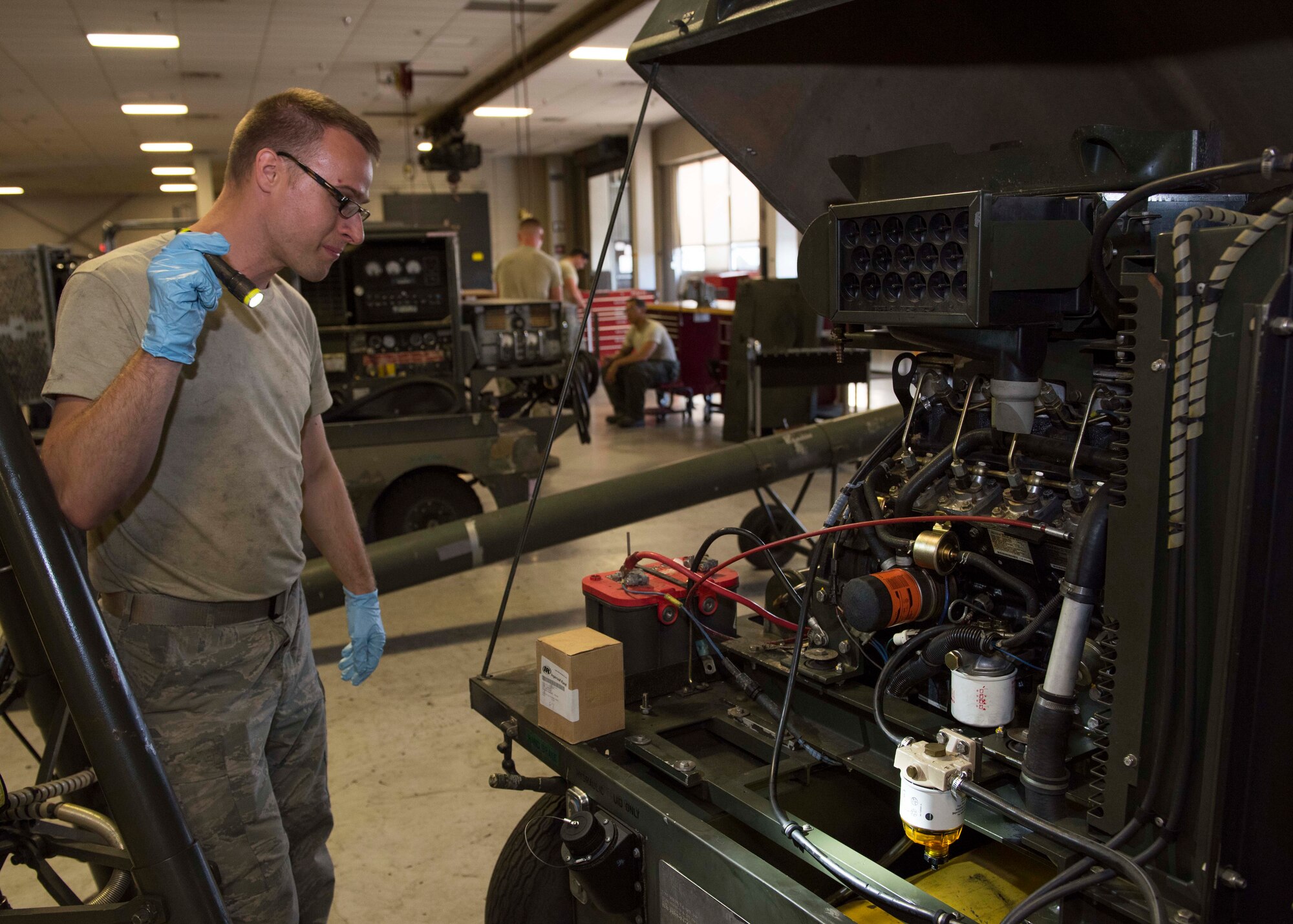 Staff Sgt. Brandon Baltis, 92nd Aerospace Ground Equipment craftsman, looks over a nitrogen cart section July 19, 2017, at Fairchild Air Force Base, Washington. Nitrogen is commonly used in aircraft tires due to its low reactivity to heat and helps maintain tire pressure longer. (U.S. Air Force photo / Airman 1st Class Ryan Lackey)