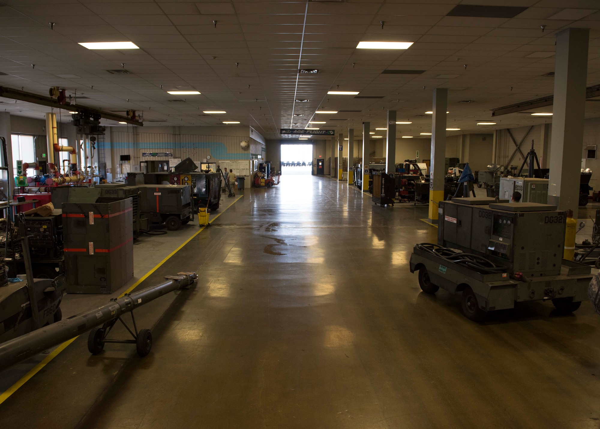 The Aerospace Ground Equipment workshop is lined with equipment such as hydraulic carts, power generators, air compressors, nitrogen tank systems and mobile diagnostic units July 19, 2017, at Fairchild Air Force Base, Washington. All equipment used to service aircraft is maintained by AGE Airmen. (U.S. Air Force photo / Airman 1st Class Ryan Lackey)