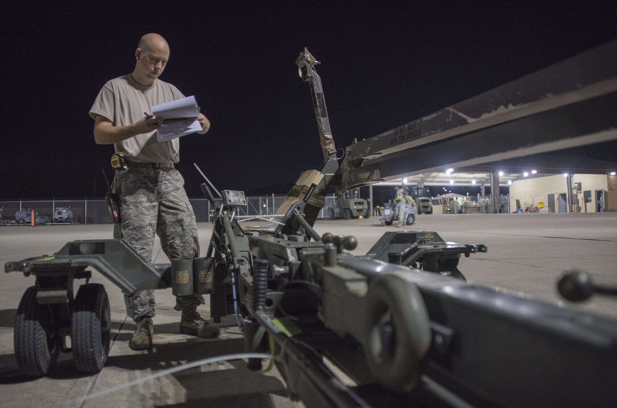 Staff Sgt. Richard Averitt, 4th Logistics Readiness Squadron air transportation specialist, verifies the dimensions and weight of a weapon loader to be loaded onto an aircraft July 20, 2017, at Seymour Johnson Air Force Base, North Carolina. This cargo was part of exercise Thunderdome 17-02, which is designed to evaluate the 4th Fighter Wing’s ability to generate and deploy aircraft, Airmen and equipment. (U.S. Air Force photo by Tech. Sgt. David W. Carbajal)