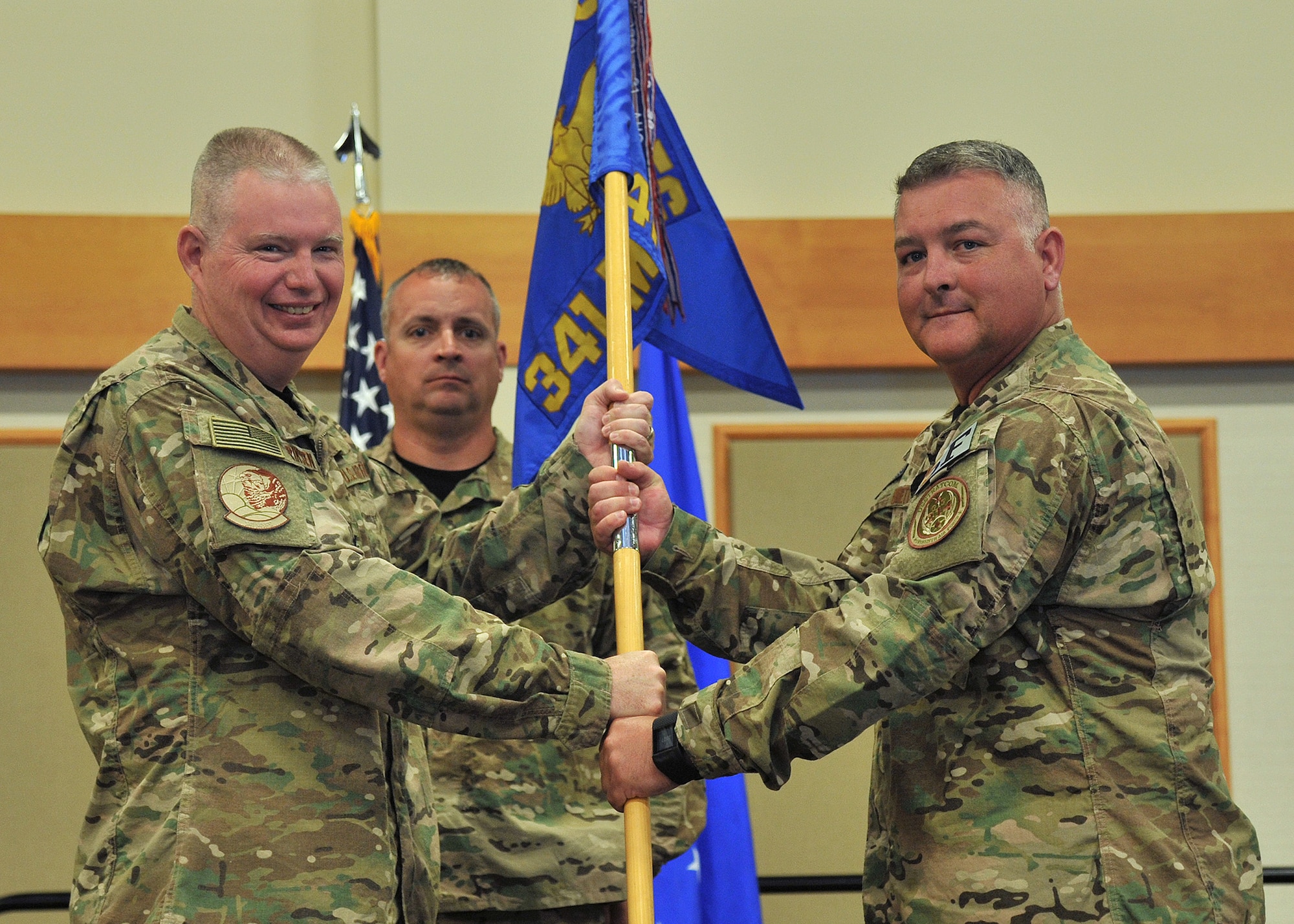 Lt. Col. Johnathan Bennett, right, accepts command of the 341st Missile Security Forces Squadron from Col. Robert Frederiksen, 341st Security Forces Group commander July 14, 2017 at Malmstrom Air Force Base, Mont. Senior Master Sgt. Shawn Wiser, 341st MSFS first sergeant, looks on. (U.S. Air Force photo/John Turner)