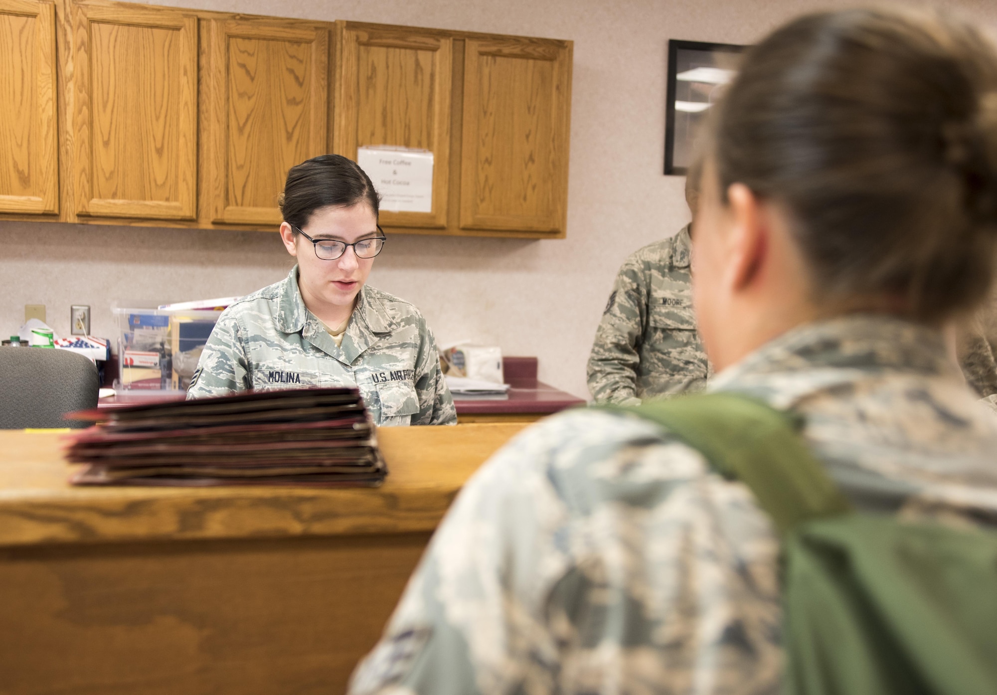 Senior Airman Natalie Molina, 4th Force Support Squadron, reviews a deployer’s mobility folder at the PDF processing center July 20, 2017, at Seymour Johnson Air Force Base, North Carolina. The pre-deployment processing was to ensure the deployers had all necessary documents and gear prior to departing. (U.S. Air Force photo by Tech. Sgt. David W. Carbajal)