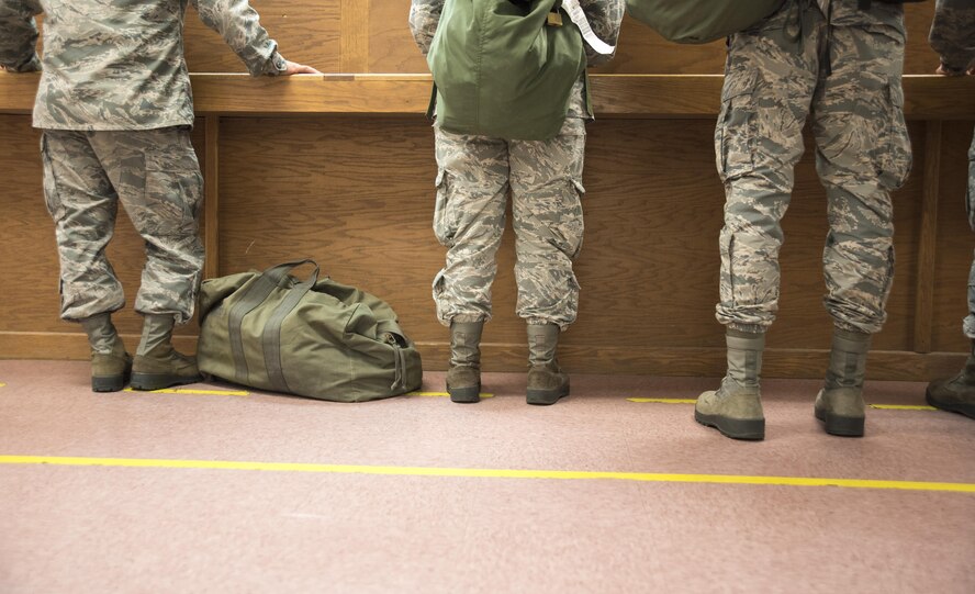 Airmen from the 4th Fighter Wing wait to have their mobility folders reviewed at the pre-deployment function line processing center July 20, 2017, at Seymour Johnson Air Force Base, North Carolina. This deployment exercise was part of Thunderdome 17-02, which is designed to evaluate the 4th Fighter Wing’s ability to rapidly generate and deploy aircraft, Airmen and equipment.  (U.S. Air Force photo by Tech. Sgt. David W. Carbajal)