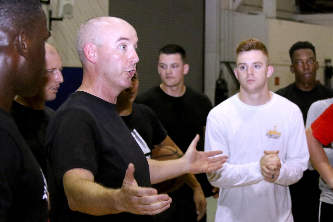 Lt. Col. Jason Donovan briefs Marines assigned to Headquarters and Headquarters Squadron prior to a double-elimination basketball tournament at Marine Corps Air Station Cherry Point, N.C., July 21, 2017. The revenue generated from the tournament lowered the ticket prices for the squadron’s annual Marine Corps ball. Donovan is the commanding officer of H&HS. (U.S. Marine Corps photo by Cpl. Jason Jimenez/ Released)