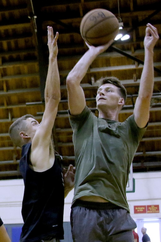 Marines assigned to Headquarters and Headquarters Squadron play basketball during a double-elimination tournament at Marine Corps Air Station Cherry Point, N.C., July 21, 2017. The revenue generated from the tournament lowered the ticket prices for the squadron’s annual Marine Corps ball. The winners received medals and bragging rights. (U.S. Marine Corps photo by Cpl. Jason Jimenez/ Released)
