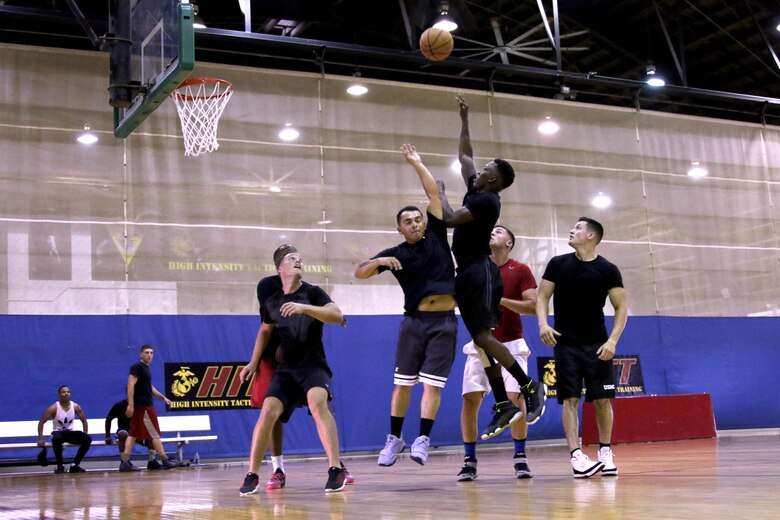 Marines assigned to Headquarters and Headquarters Squadron play basketball during a double-elimination tournament at Marine Corps Air Station Cherry Point, N.C., July 21, 2017. Teams faced each other to determine which squad had the best players. The revenue generated from the tournament lowered the ticket prices for the squadron’s annual Marine Corps ball. (U.S. Marine Corps photo by Cpl. Jason Jimenez/ Released)