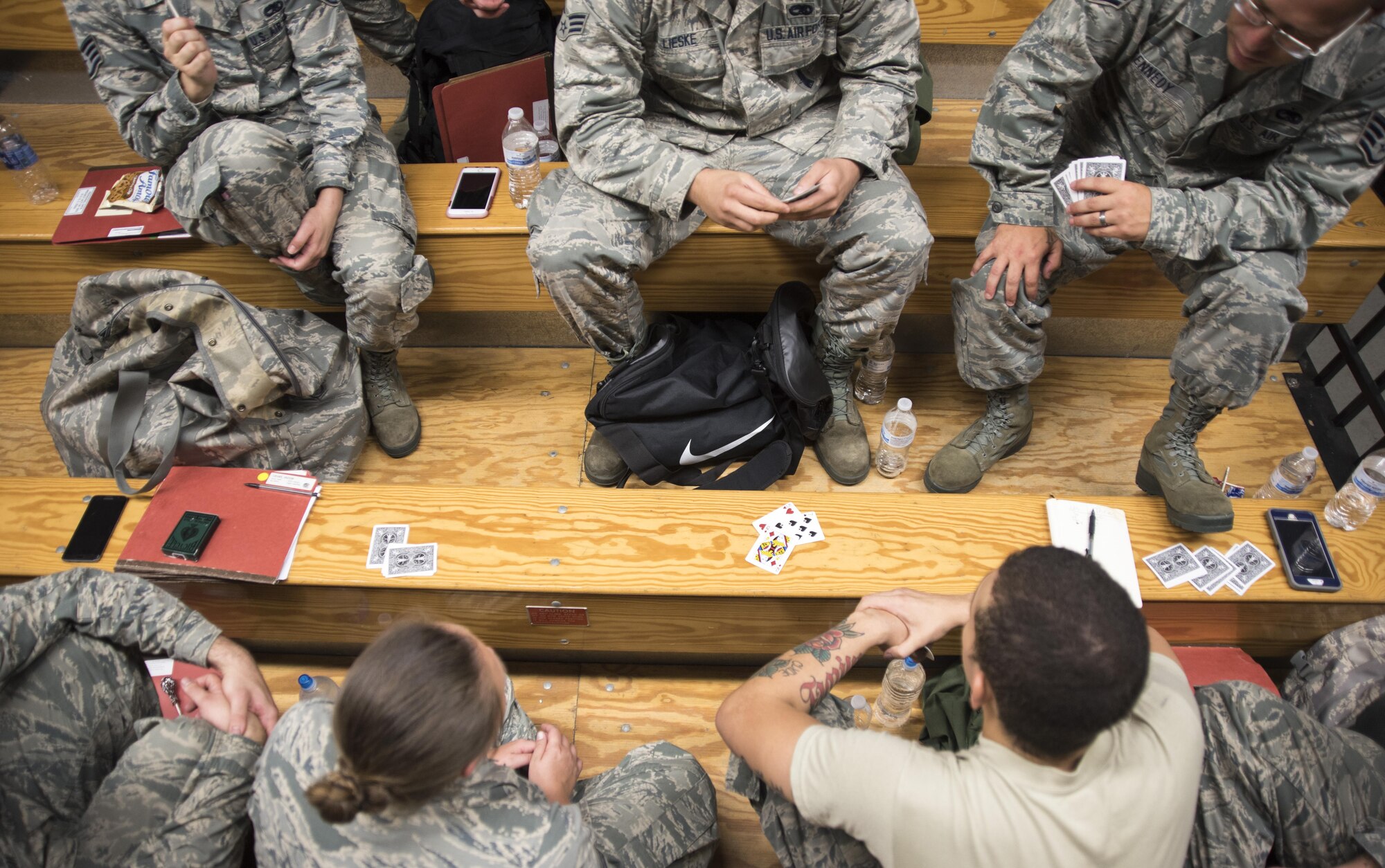 Airmen from the 4th Aircraft Maintenance Squadron play a game of spades while waiting at the pre-deployment function line processing center July 20, 2017, at Seymour Johnson Air Force Base, North Carolina. Airmen watched movies, played games and rested while waiting to be processed through the PDF line. (U.S. Air Force photo by Tech. Sgt. David W. Carbajal)