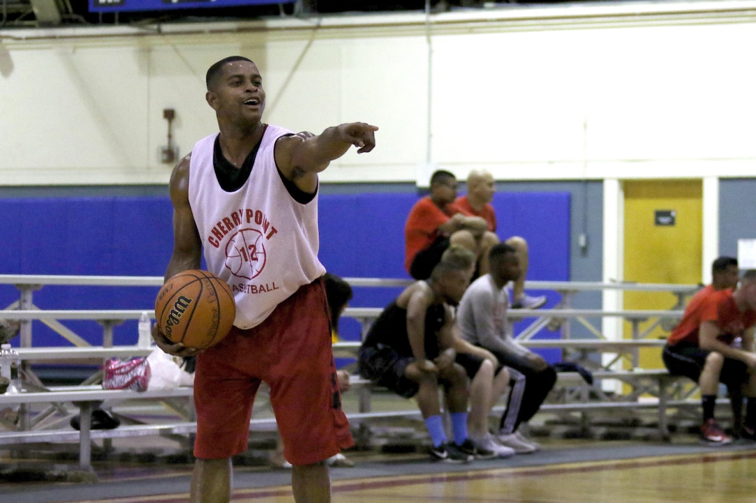 Cpl. Brian Doyle initiates a play during Headquarters and Headquarters Squadron basketball tournament at Marine Corps Air Station Cherry Point, N.C., July 21, 2017. The revenue generated from the tournament lowered the ticket prices for the squadron’s annual Marine Corps ball. Doyle is a bulk fuel specialist with H&HS. (U.S. Marine Corps photo by Cpl. Jason Jimenez/ Released)