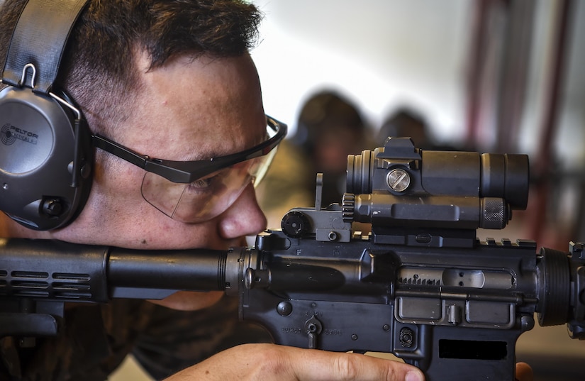 Airman Dalton Green, 437th Aircraft Maintenance Squadron environmental and electronic systems apprentice, goes through firing procedures during augmentee training at Joint Base Charleston, S.C., July 20, 2017. Augmentees trained in weapons familiarization and fired the M4 carbine rifle and the M9 pistol. 