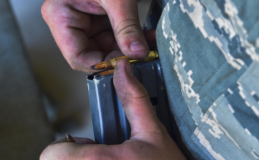 Airman Dalton Goode, 437th Aircraft Maintenance Squadron crew chief, loads a magazine during augmentee training at Joint Base Charleston, S.C., July 20, 2017. Augmentees trained in weapons familiarization and fired the M4 carbine rifle and the M9 pistol.