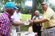 Tommy Wiggington, retired Chief Master Sgt. David Curtis, and retired Chief Master Sgt. Dallas Godfrey serve ears of corn to people attending the annual Corn and Sausage Roast held on Dobbins Air Reserve Base, Ga. July 19, 2017. The event's proceeds, along with assistance from the Dobbins Thrift Store, benefit the Dobbins Emergency Relief Fund. (U.S. Air Force photo/Don Peek) 