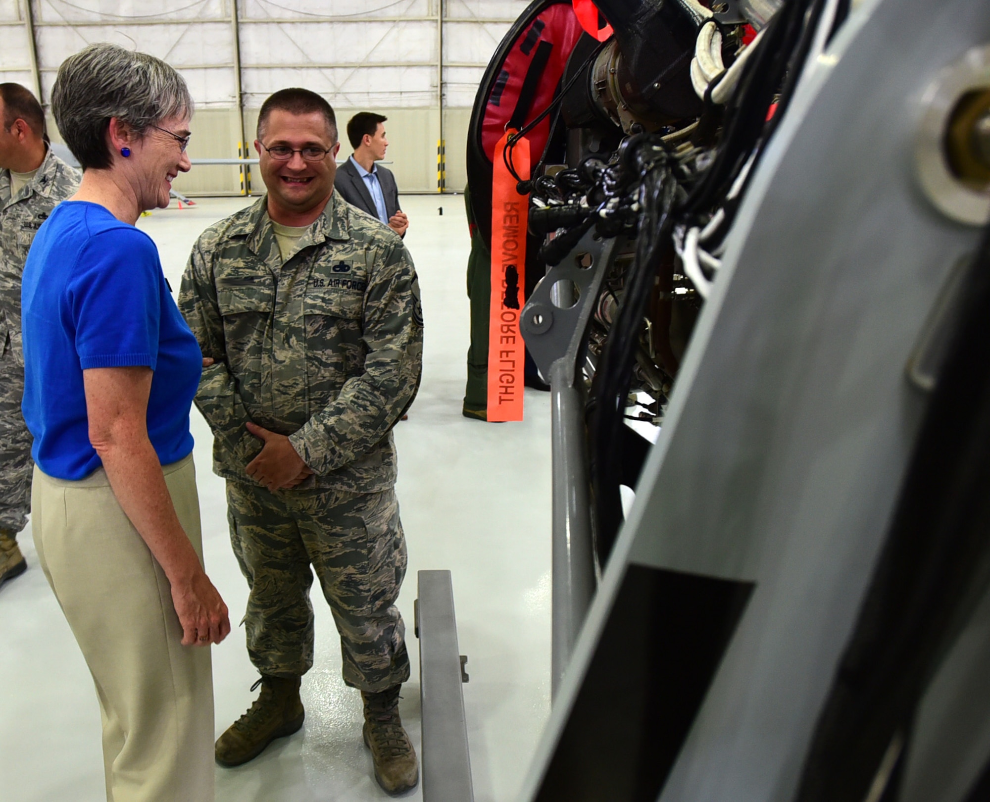 Secretary of the Air Force Heather Wilson shares a laugh with Master Sgt. Eric, 432nd Aircraft Maintenance Squadron production superintendent, July 19, 2017, at Creech Air Force Base, Nev. Eric briefed the SecAF on an engine trainer he created in his spare time to fill a training need within the squadron. He said it was a unique opportunity to show her his creation. (U.S. Air Force photo/Senior Airman Christian Clausen)