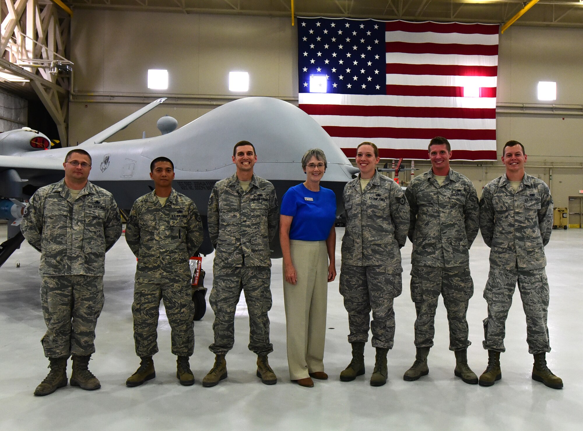 Secretary of the Air Force Heather Wilson shares a photo with members of the 432nd Aircraft Maintenance Squadron, July 19, 2017, at Creech Air Force Base, Nev. The AMXS maintainers briefed the SecAF on the MQ-1 Predator and MQ-9 Reaper specifics. (U.S. Air Force photo/Senior Airman Christian Clausen)