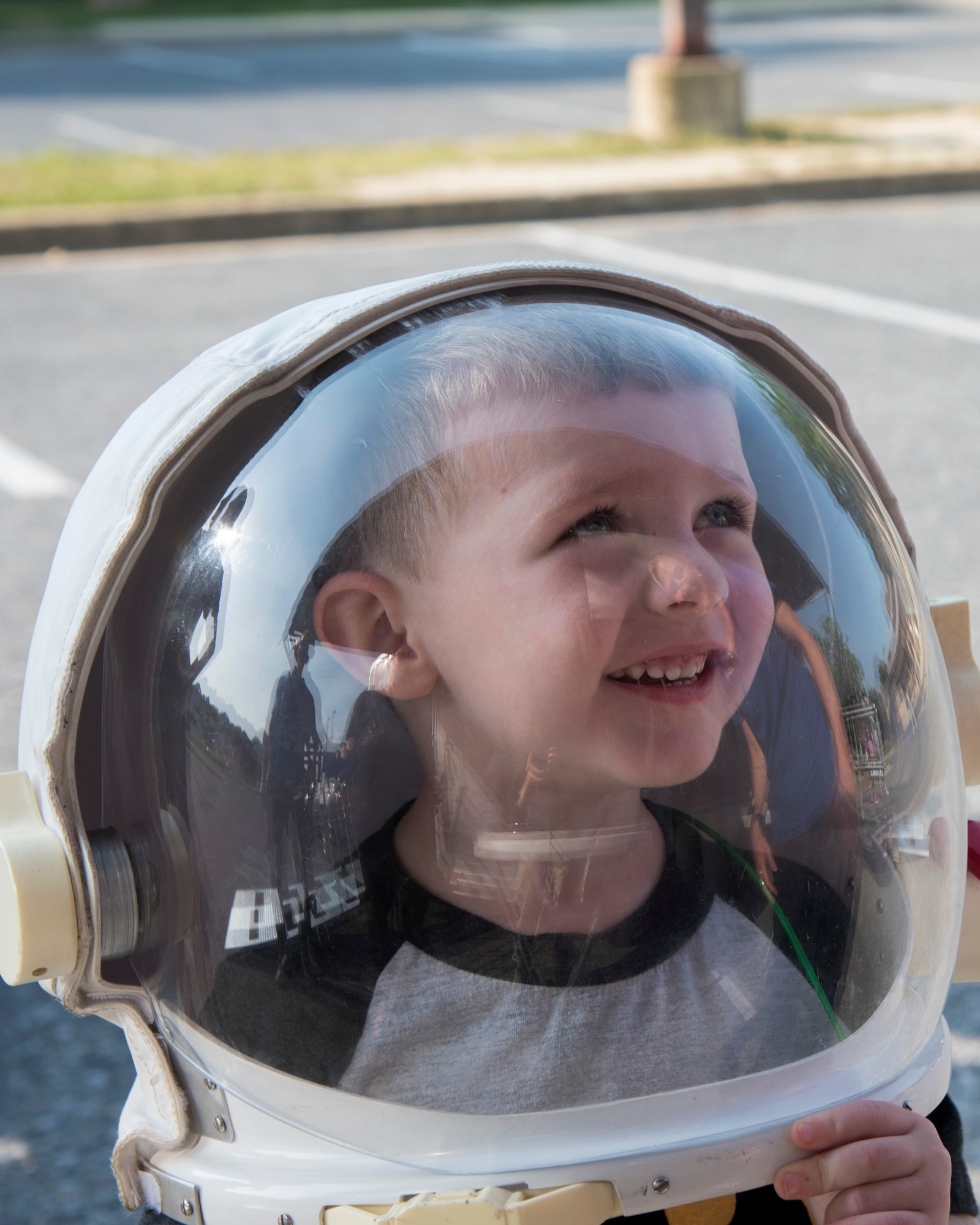 A child tries on an astronaut helmet during a National Aeronautics and Space Administration Science, Technology, Engineering, and Mathematics Day at Joint Base Andrews, Md., July 14, 2017. The event included NASA’s Driven to Explore mobile exhibit, immersing attendees in NASA and specifically, the International Space Station experience. (U.S. Air Force photo by Airman 1st Class Valentina Lopez)
