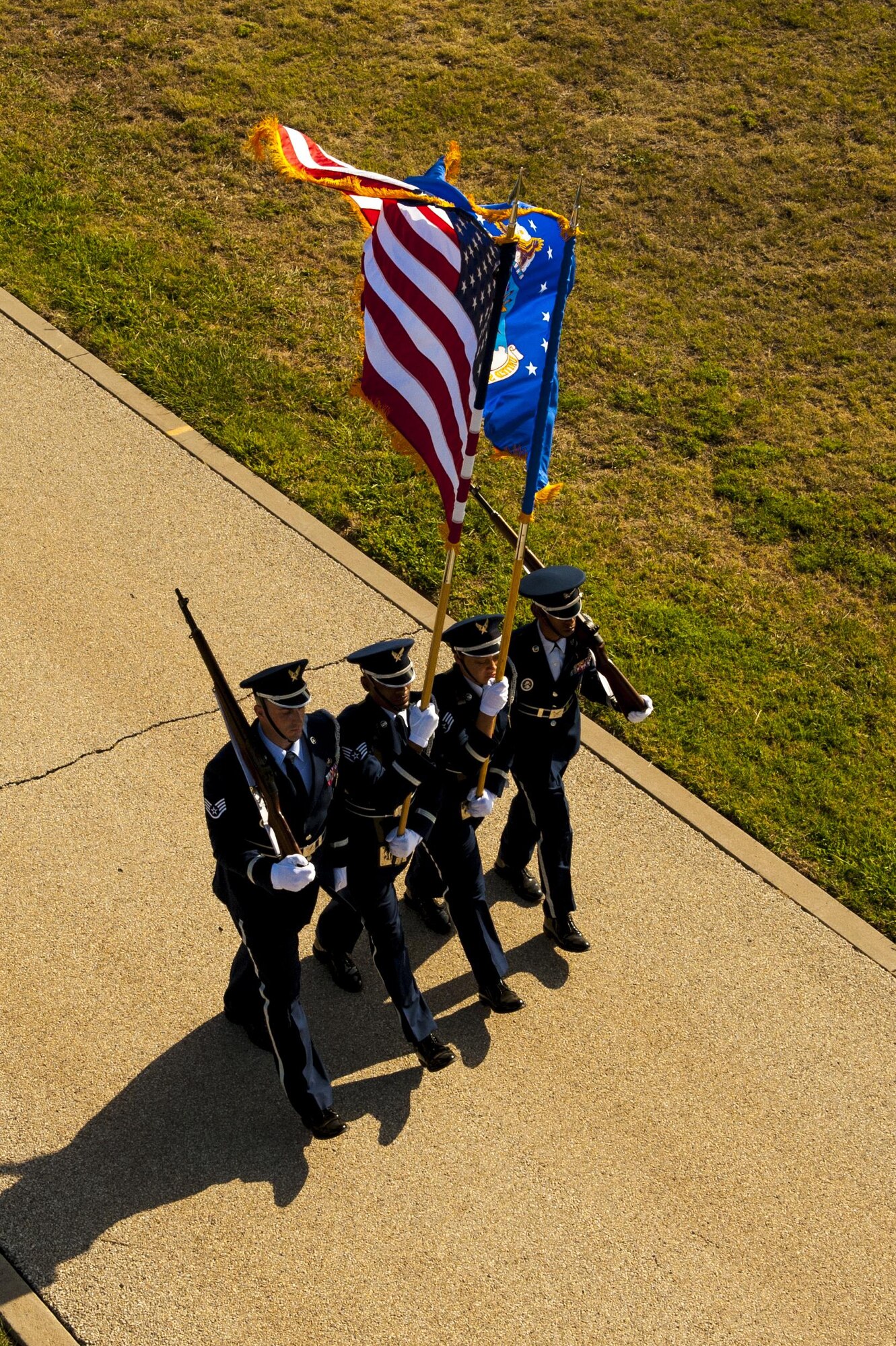 Goodfellow Air Force Base honor guard march on the parade field during the 17th Training Wing change of command on Goodfellow Air Force Base, Texas, July 21, 2017. The ceremony signifies relinquishment of command from U.S. Air Force Col. Michael Downs to Col. Ricky Mills. (U.S. Air Force photo by Senior Airman Scott Jackson/Released)