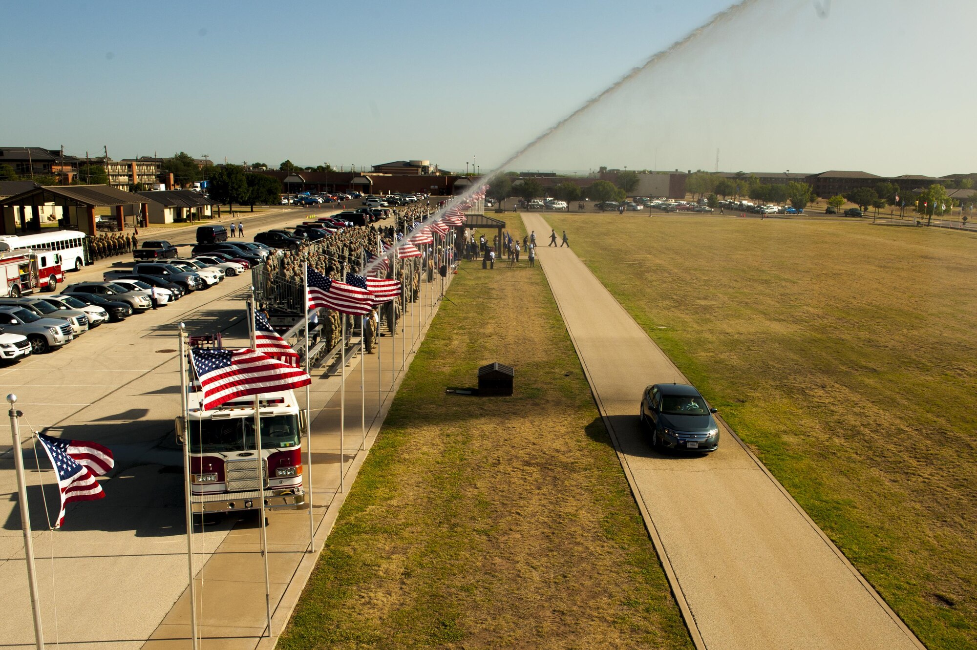 A firetruck gives a farewell water arc for U.S. Air Force Col. Michael Downs as he departs the parade field for his dedication as the wing commander during the 17th Training Wing change of command ceremony on Goodfellow Air Force Base, Texas, July 21, 2017. The change of command ceremony is a time honored military tradition that signifies the orderly transfer of authority. (U.S. Air Force photo by Senior Airman Scott Jackson/Released)