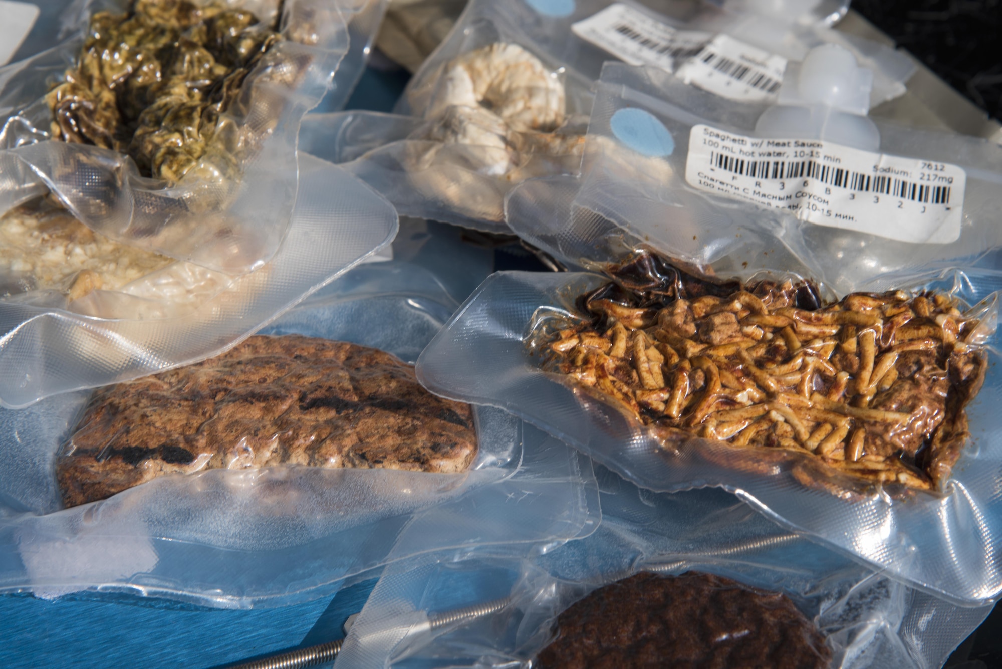 Vacuum sealed astronaut food packages were on display during a National Aeronautics and Space Administration’s Science, Technology, Engineering, and Mathematics Day at Joint Base Andrews, Md., July 14, 2017. The event showcased NASA’s Driven to Explore mobile exhibit that included audiovisual technology, astronaut food, a spacesuit photo opportunity, or astronaut glove and helmet mock training, and one of eight touchable moon rocks in the world. (U.S. Air Force photo by Airman 1st Class Valentina Lopez)
