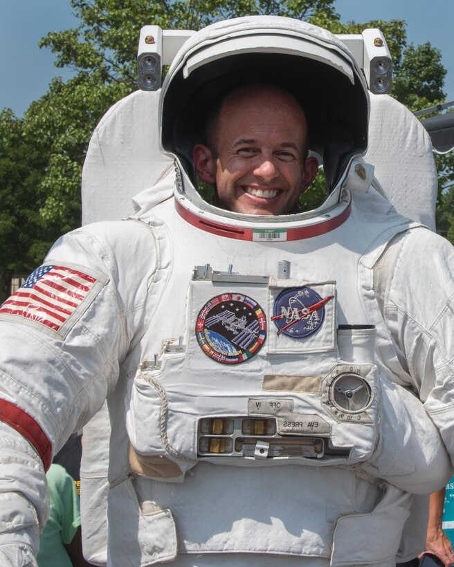 Col. E. John Teichert, 11th Wing and Joint Base Andrews commander, poses for a photograph in a spacesuit during a National Aeronautics and Space Administration’s Science, Technology, Engineering, and Mathematics Day at Joint Base Andrews, Md., July 14, 2017. Participants learned about astronaut nutrition, spaceman suits and the International Space Station. (U.S. Air Force photo by Airman 1st Class Valentina Lopez)