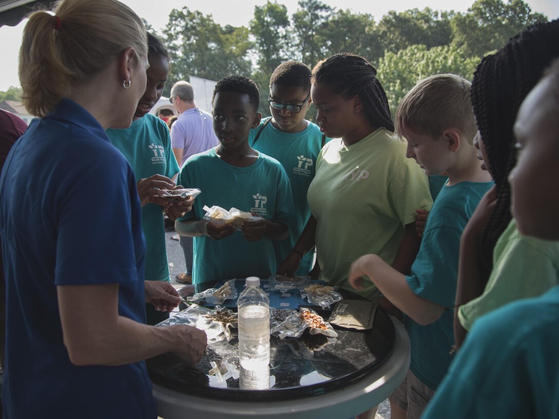 Participants examine astronaut food during a National Aeronautics and Space Administration’s Science, Technology, Engineering, and Mathematics Day at Joint Base Andrews, Md., July 14, 2017. Participants learned about spaceman nutrition, astronaut suits and the International Space Station. (U.S. Air Force photo by Airman 1st Class Valentina Lopez)