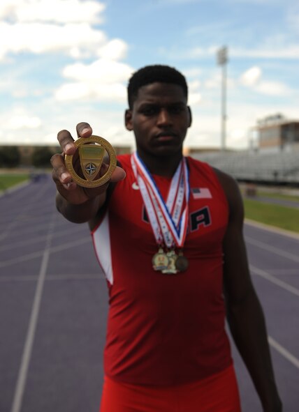 U.S. Air Force Senior Airman Parnelle Shands 317th Aircraft Maintenance Squadron crew chief, holds a gold medal he won at the AirCom Athletics Championship for track and field at Abilene Christian University, Texas, July 13, 2017. Shands won first place in the long jump event, fourth place in the 100-meter dash, and second place in a 4x100 relay against nations such as Poland, Germany, Belgium, the Netherlands and the United Kingdom. (U.S. Air Force photo by Airman Kylee Thomas)
