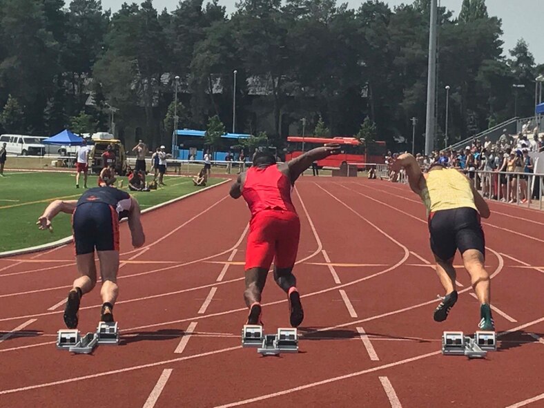 U.S. Air Force Senior Airman Parnelle Shands, center, 317th Aircraft Maintenance Squadron crew chief, sprints against competitors in the 100-meter dash at the AirCom Athletics Championships for track and field at Kaiserslautern, Germany, June 21, 2017. Shands won fourth place in the event with a time of 10.84. (Courtesy photo)
