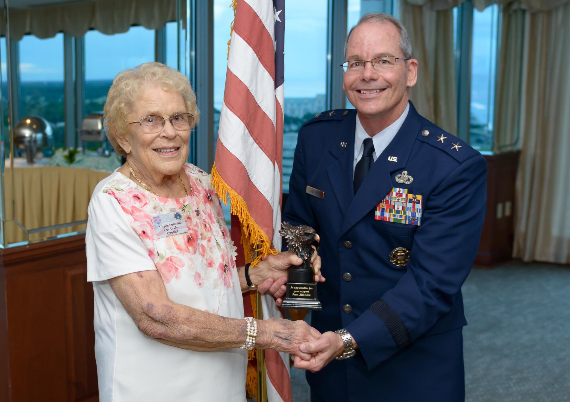 Retired Col. Phyllis Luttman, Mississippi Coast Military Officers Association vice president, presents Maj. Gen. Bob LaBrutta, 2nd Air Force commander, with a token of appreciation during the MCMOA dinner at the Great Southern Club July 12, 2017, Gulfport, Miss. The dinner was held to familiarize the MCMOA members with the current readiness level of the 2nd AF. (U.S. Air Force photo by Andre’ Askew)