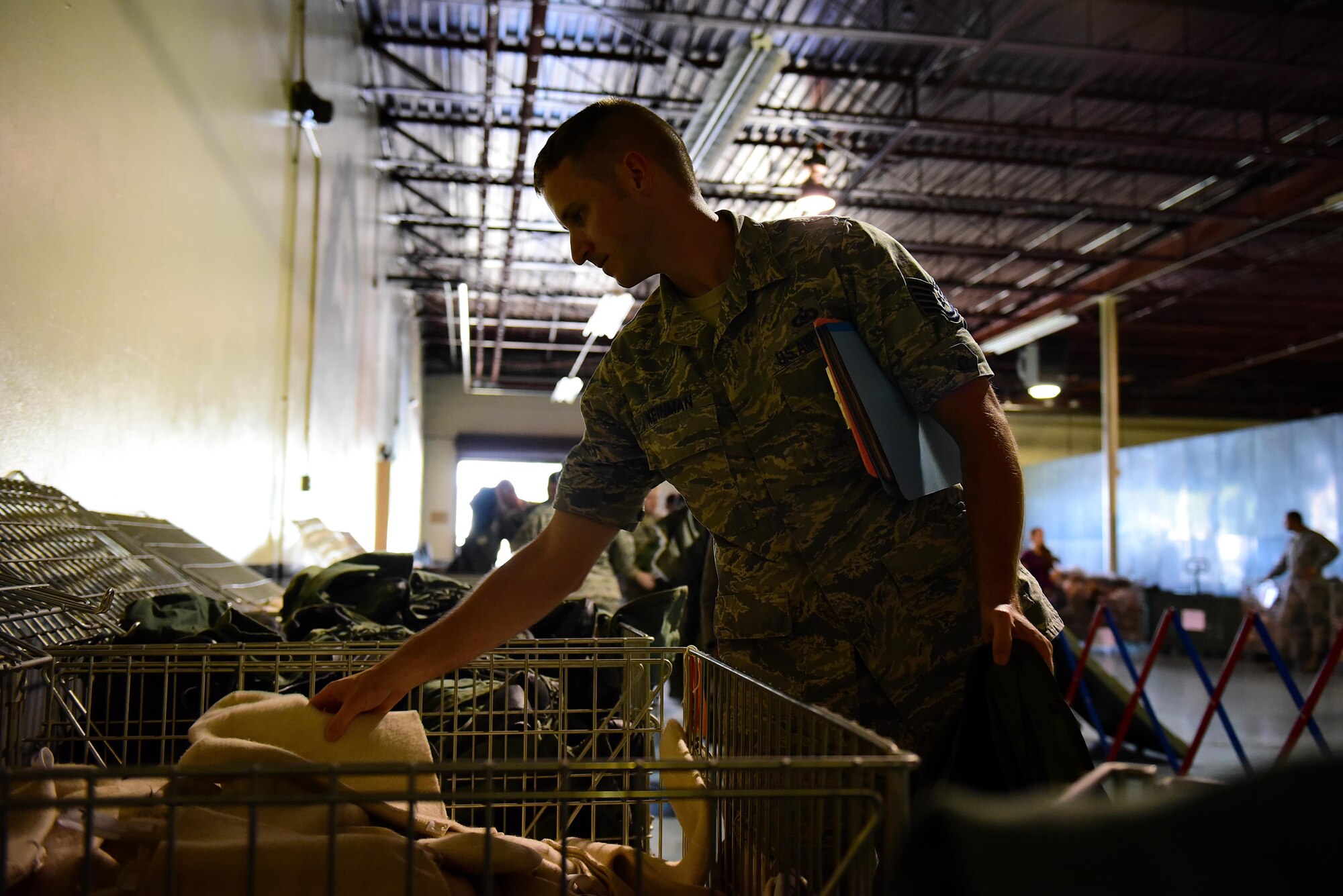 Tech Sgt. Austin Weinman, 4th Operations Support Squadron non-commissioned officer in charge of 335th Fighter Squadron aircrew flight equipment, takes issued equipment for exercise Thunderdome 17-02, July 20, 2017, at Seymour Johnson Air Force Base, North Carolina. During the first phase of the exercise, deploying members were identified, medically cleared, equipped with any necessary gear and briefed on all information needed to conduct operations in the simulated area of responsibility. (U.S. Air Force photo by Airman 1st Class Kenneth Boyton)